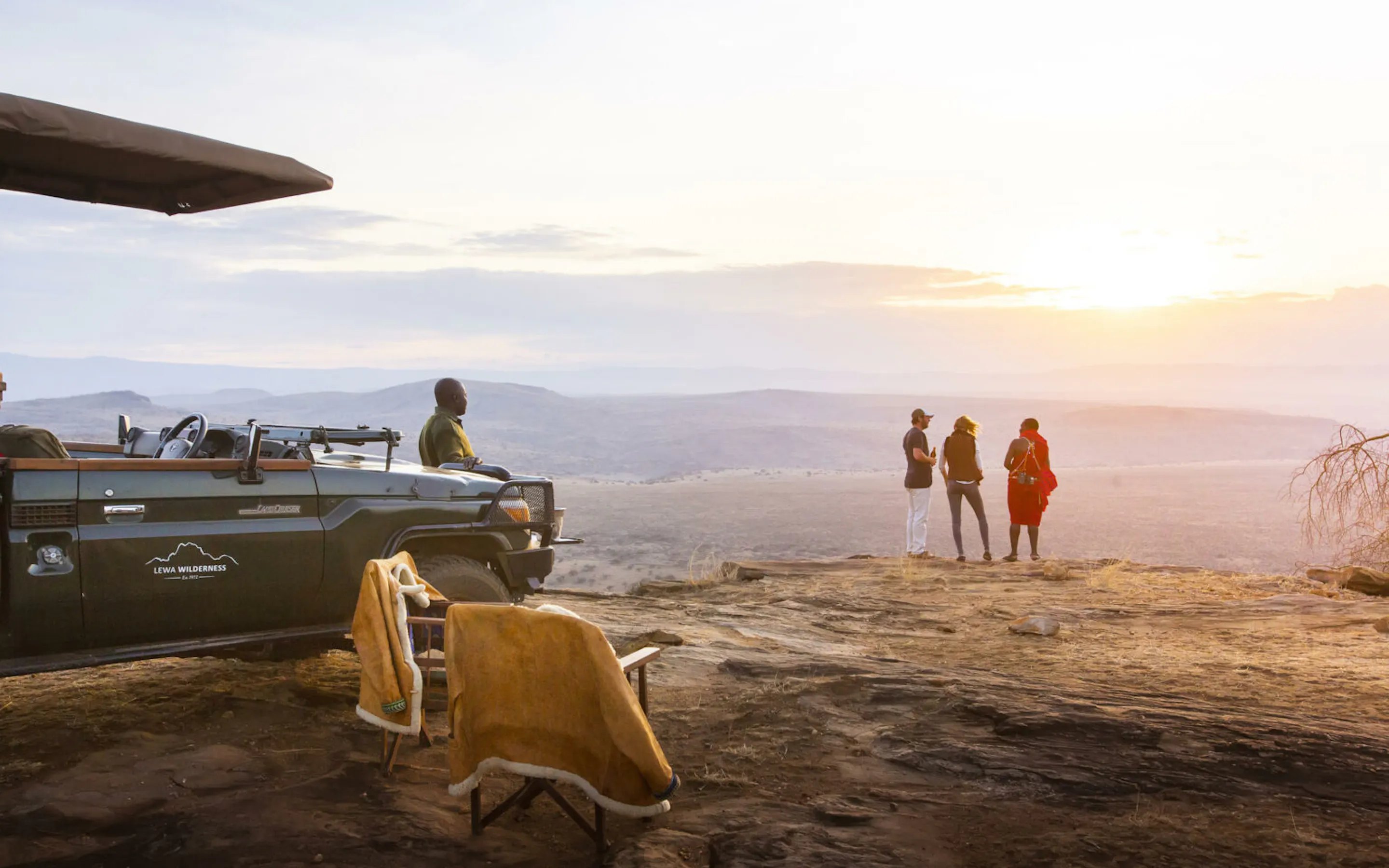 Open plains stretch toward Mount Kenya in Laikipia, with dry grassland and distant hills beneath a bright sky.