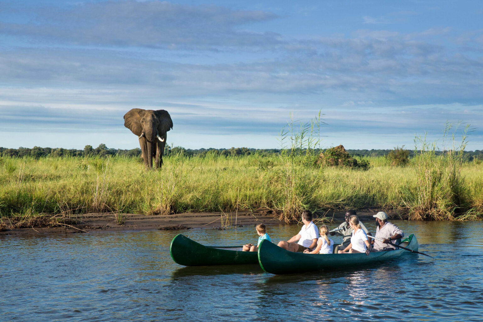 Tembo Plains guests get up-close to an elephant on a Zambezi River canoe safari in Zimbabwe's Mana Pools.