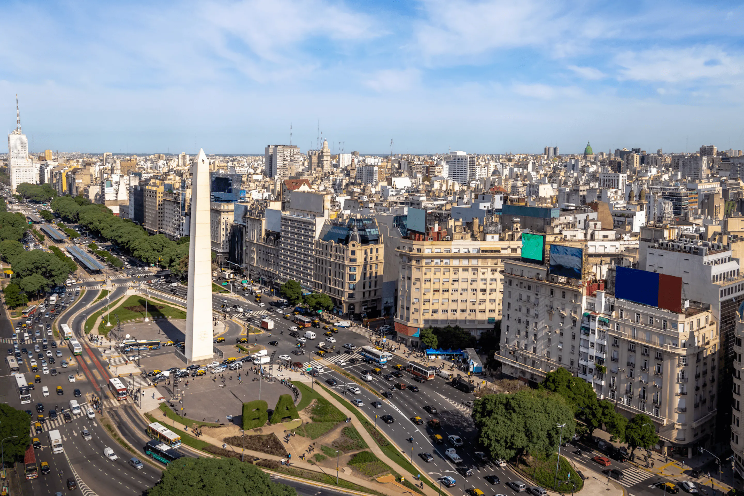 The Obelisk and broad lanes of 9 de Julio Avenue cut through central Buenos Aires beneath a clear morning sky.