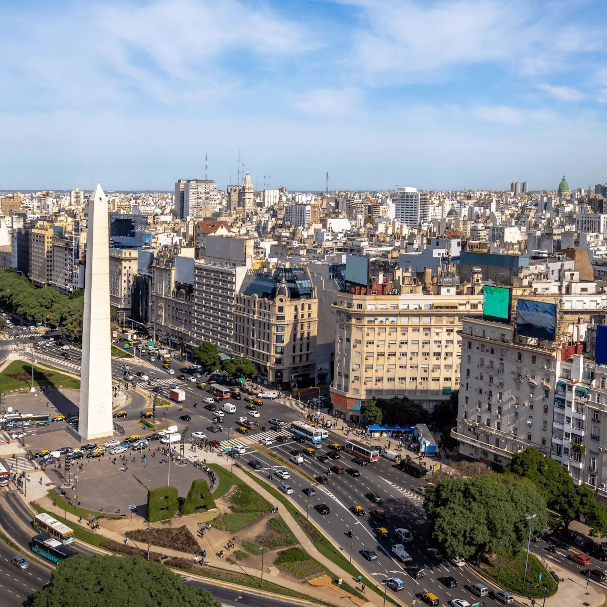 The Obelisk and broad lanes of 9 de Julio Avenue cut through central Buenos Aires beneath a clear morning sky.