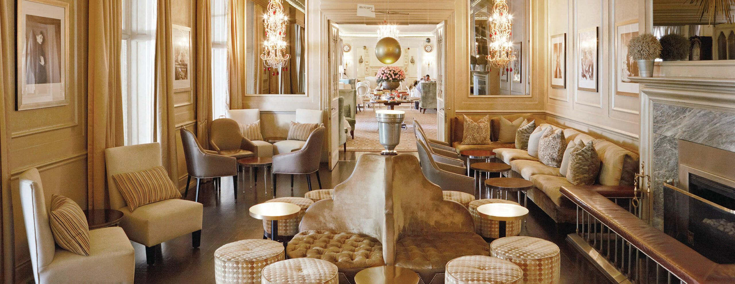 An elegant hotel bar with cream seating and warm lighting at Mount Nelson, A Belmond Hotel, set in Cape Town.
