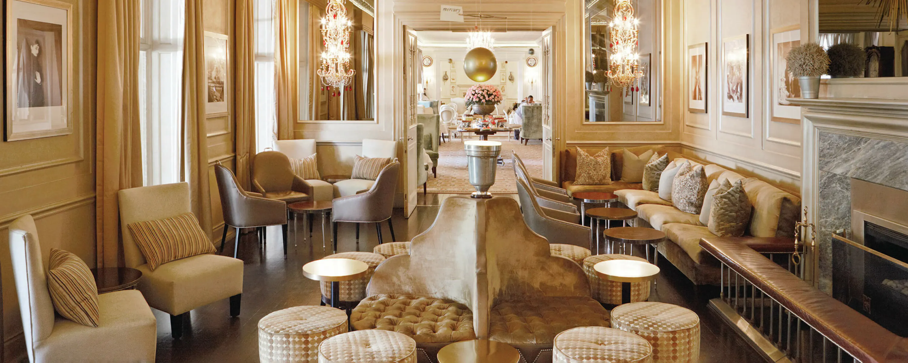 An elegant hotel bar with cream seating and warm lighting at Mount Nelson, A Belmond Hotel, set in Cape Town.