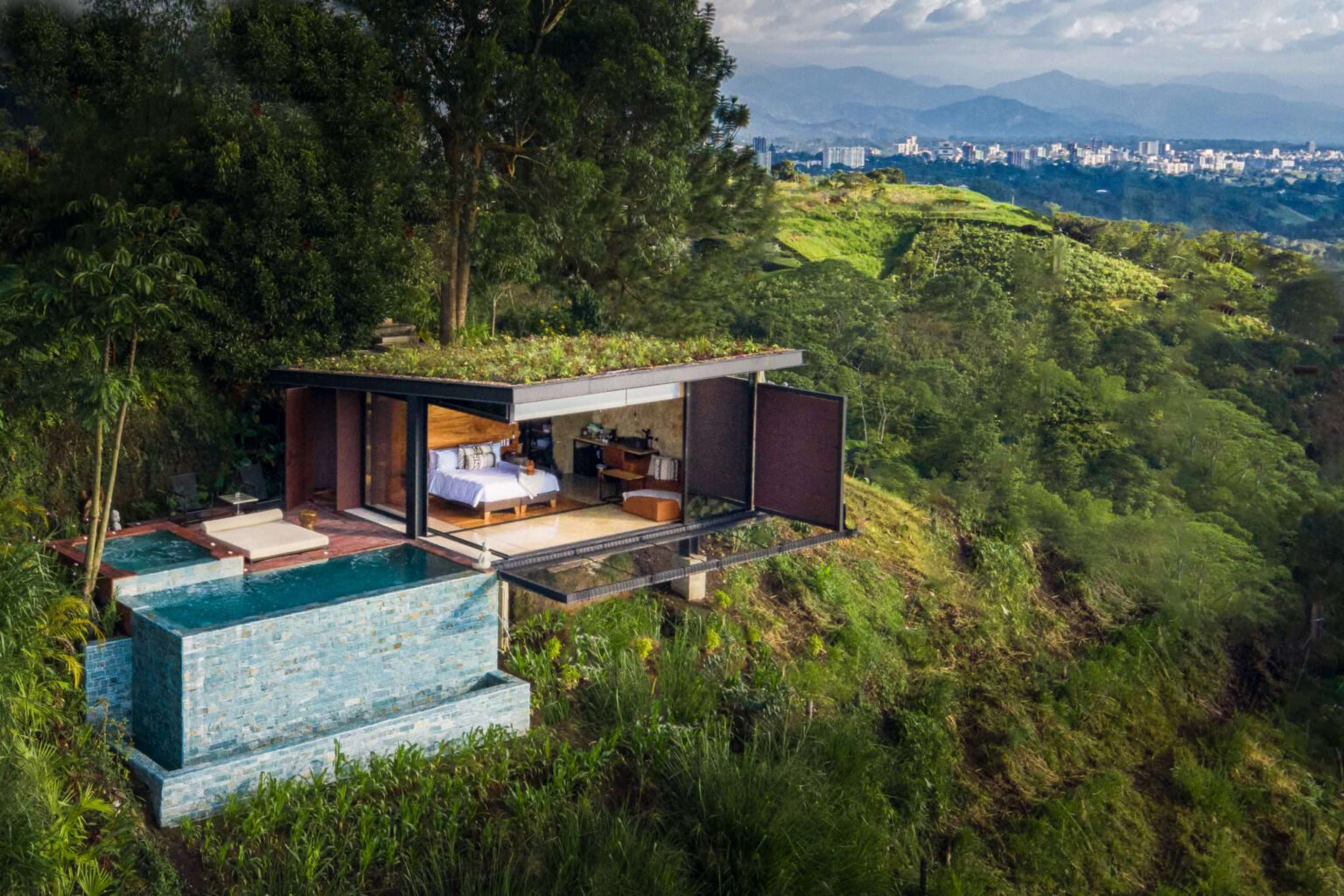A mountain lodge with a plunge pool above green hills at Bio Habitat Hotel, set in near Medellin, Colombia.