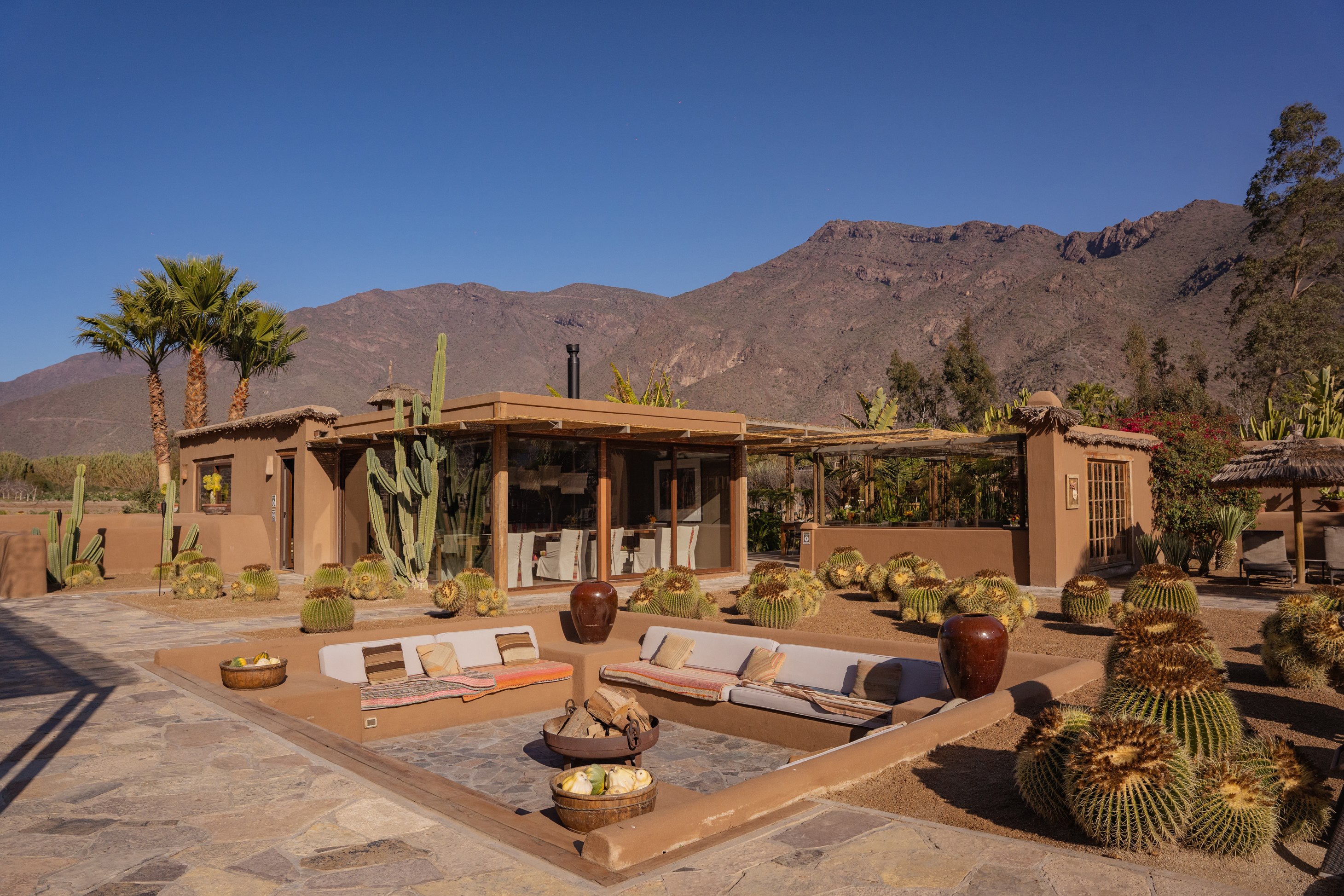 outdoor firepit and house with mountains behind