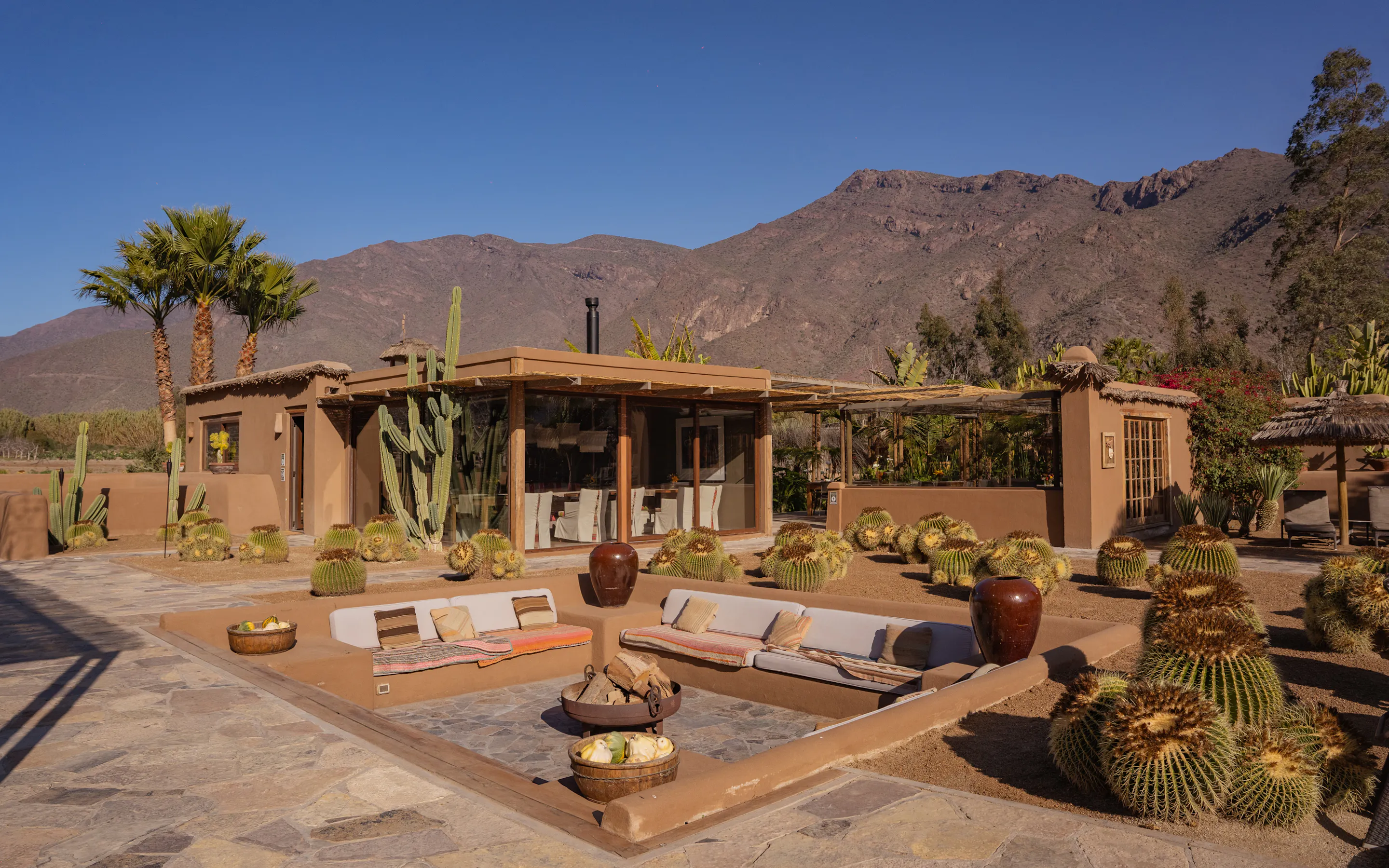 outdoor firepit and house with mountains behind