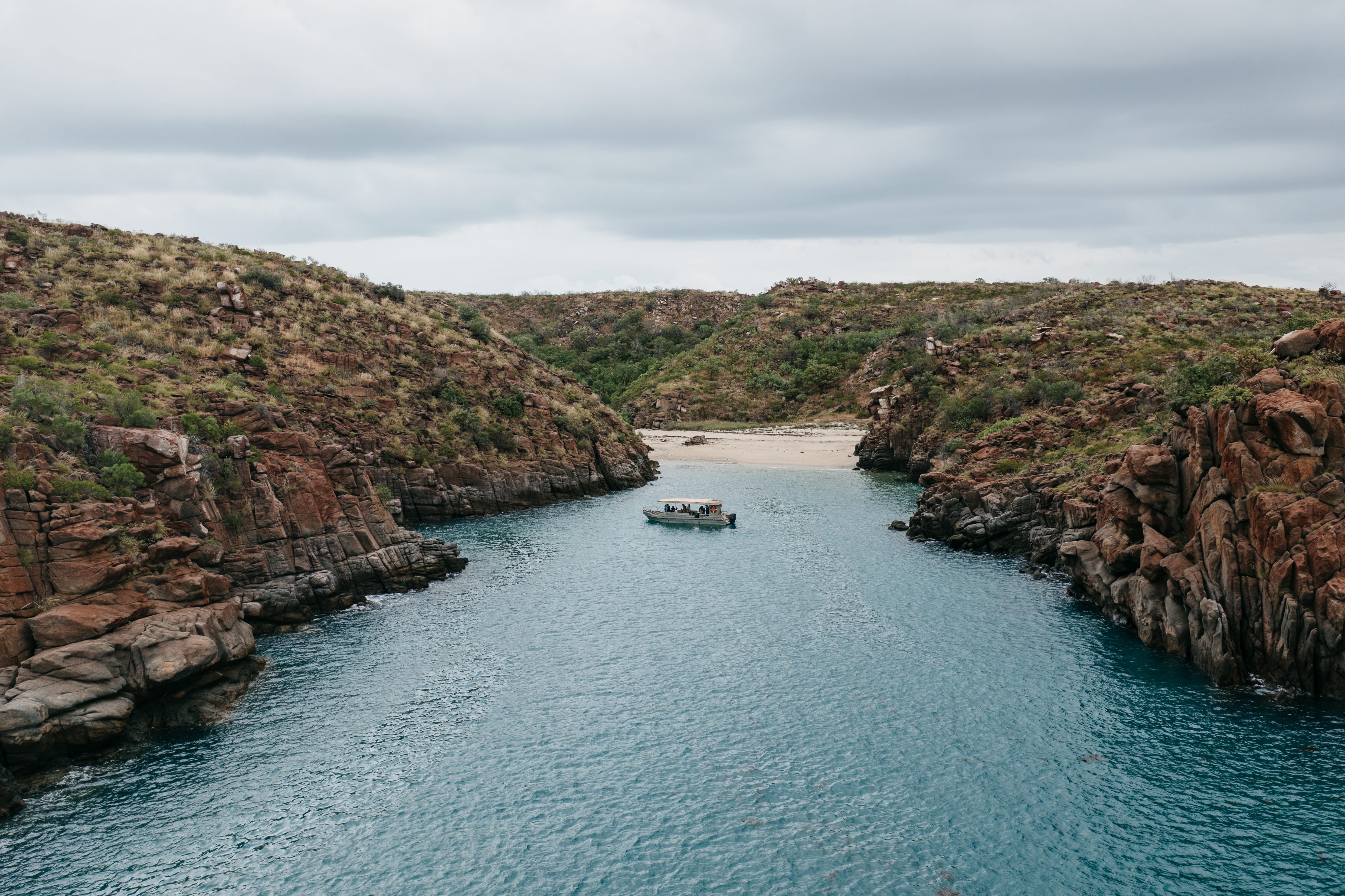 Boat by a bay and beach in the background