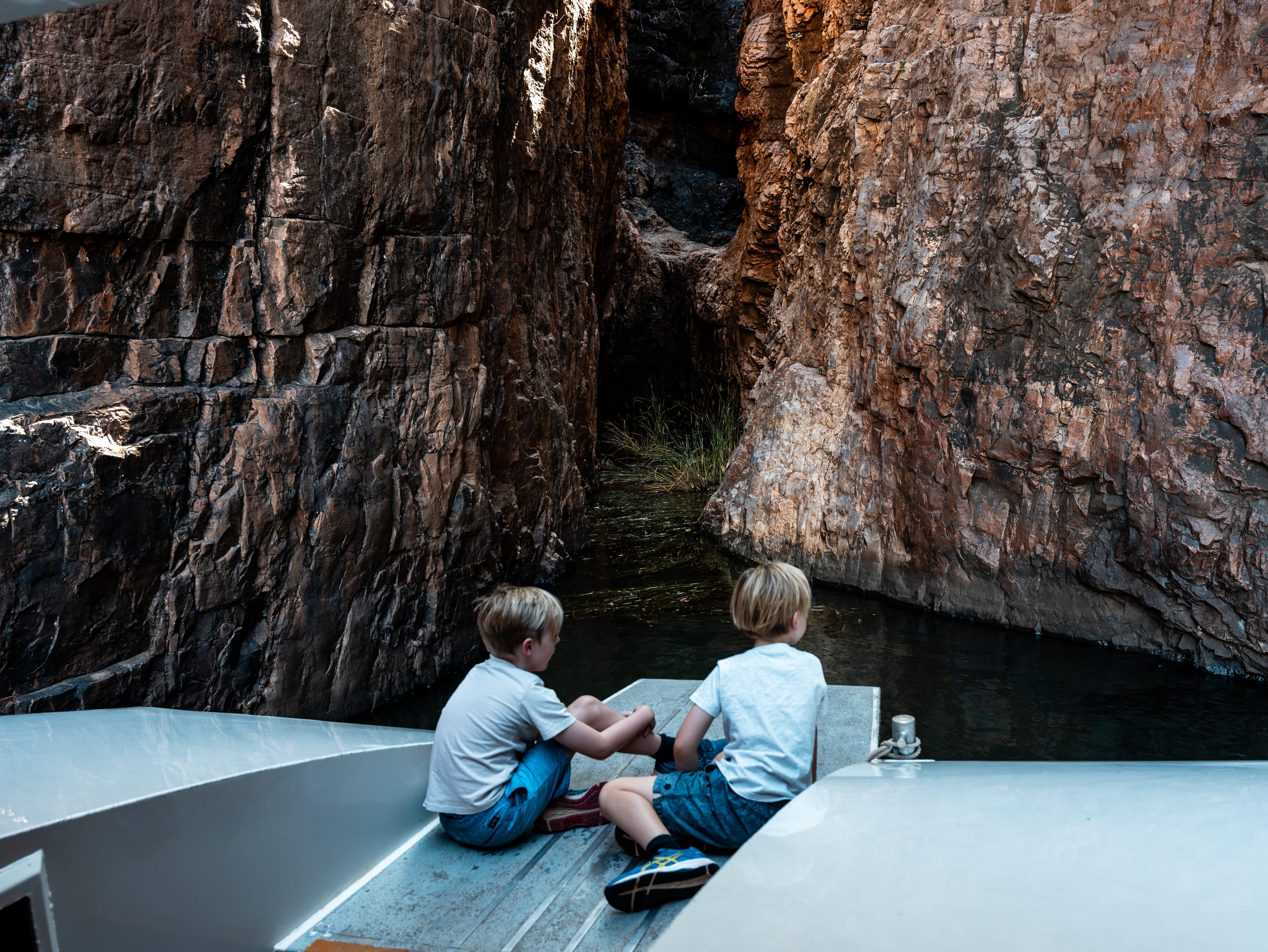 children on boat in a cave