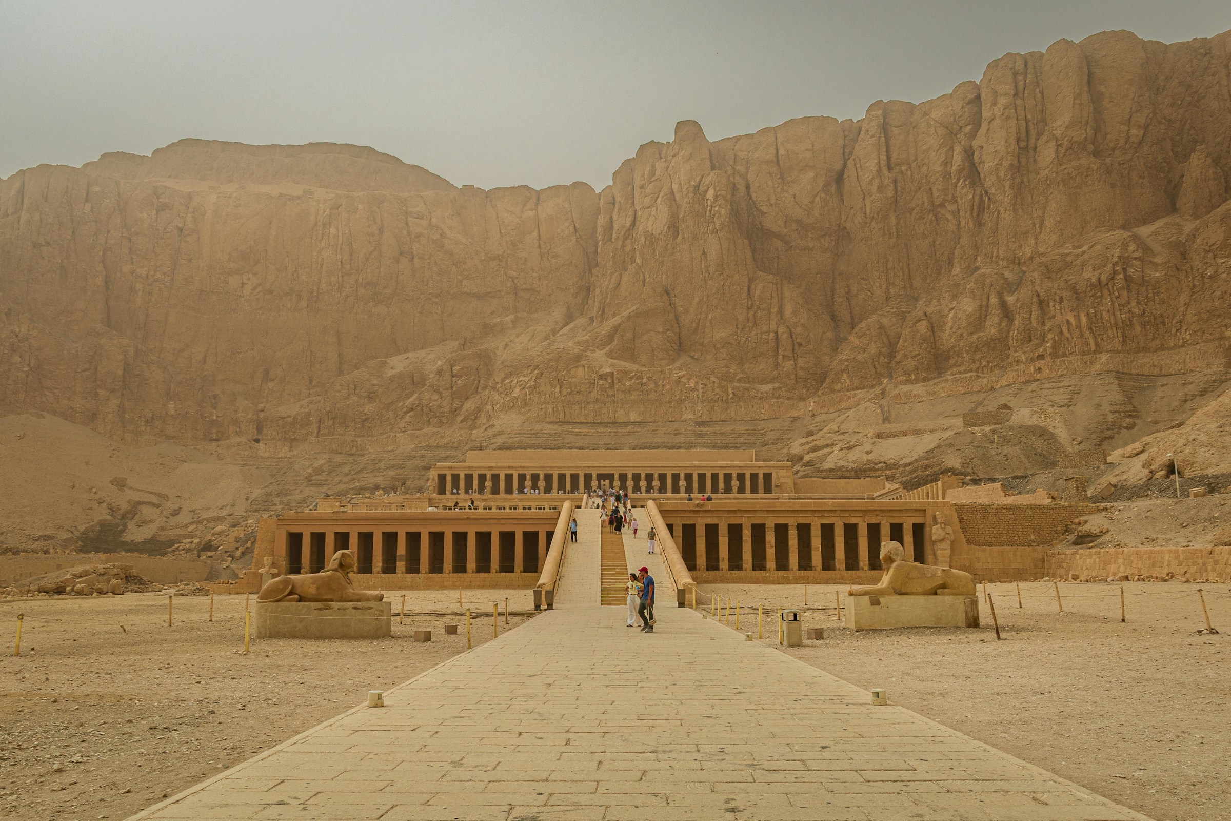 temple in the desert with mountains in the back