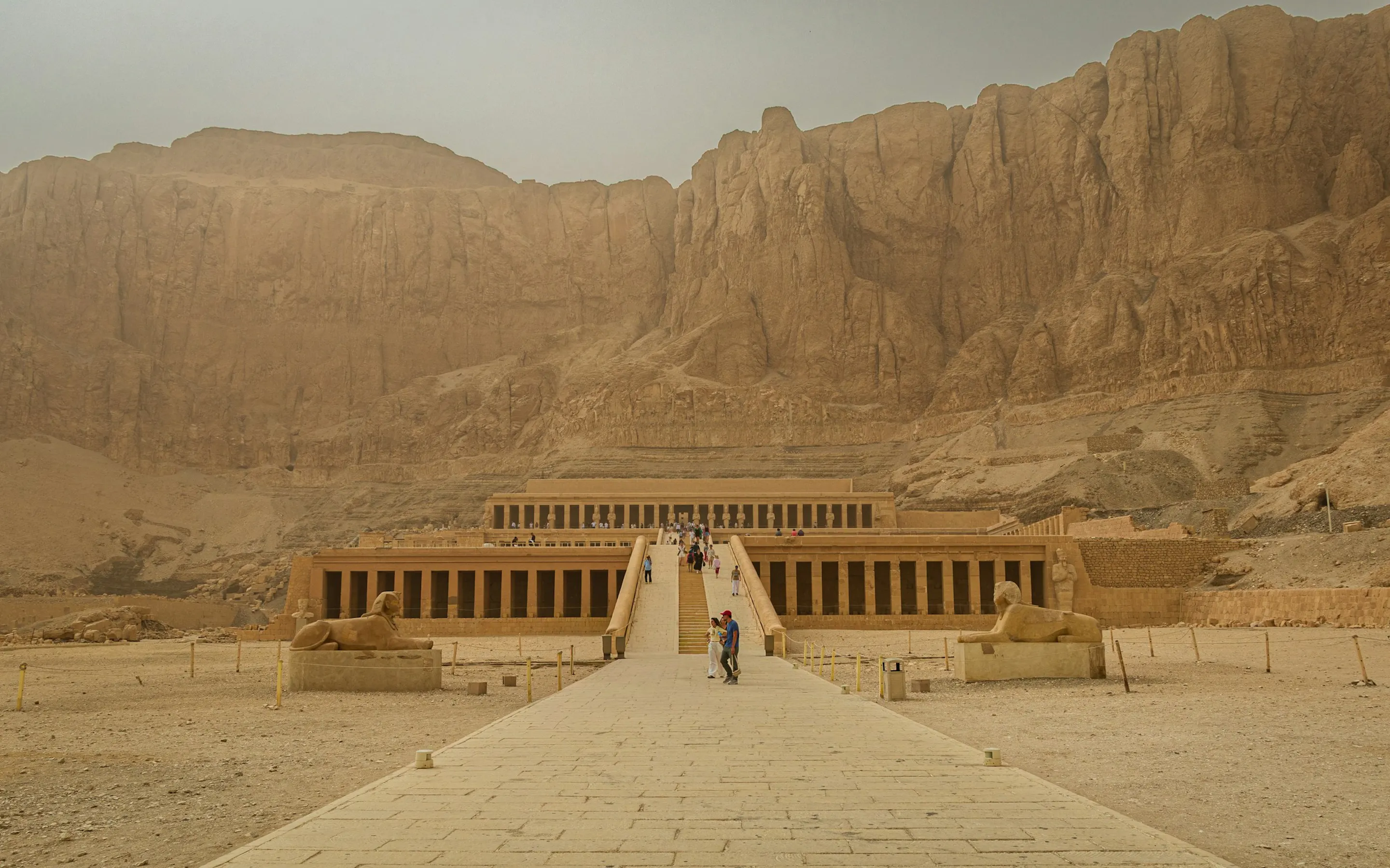 temple in the desert with mountains in the back