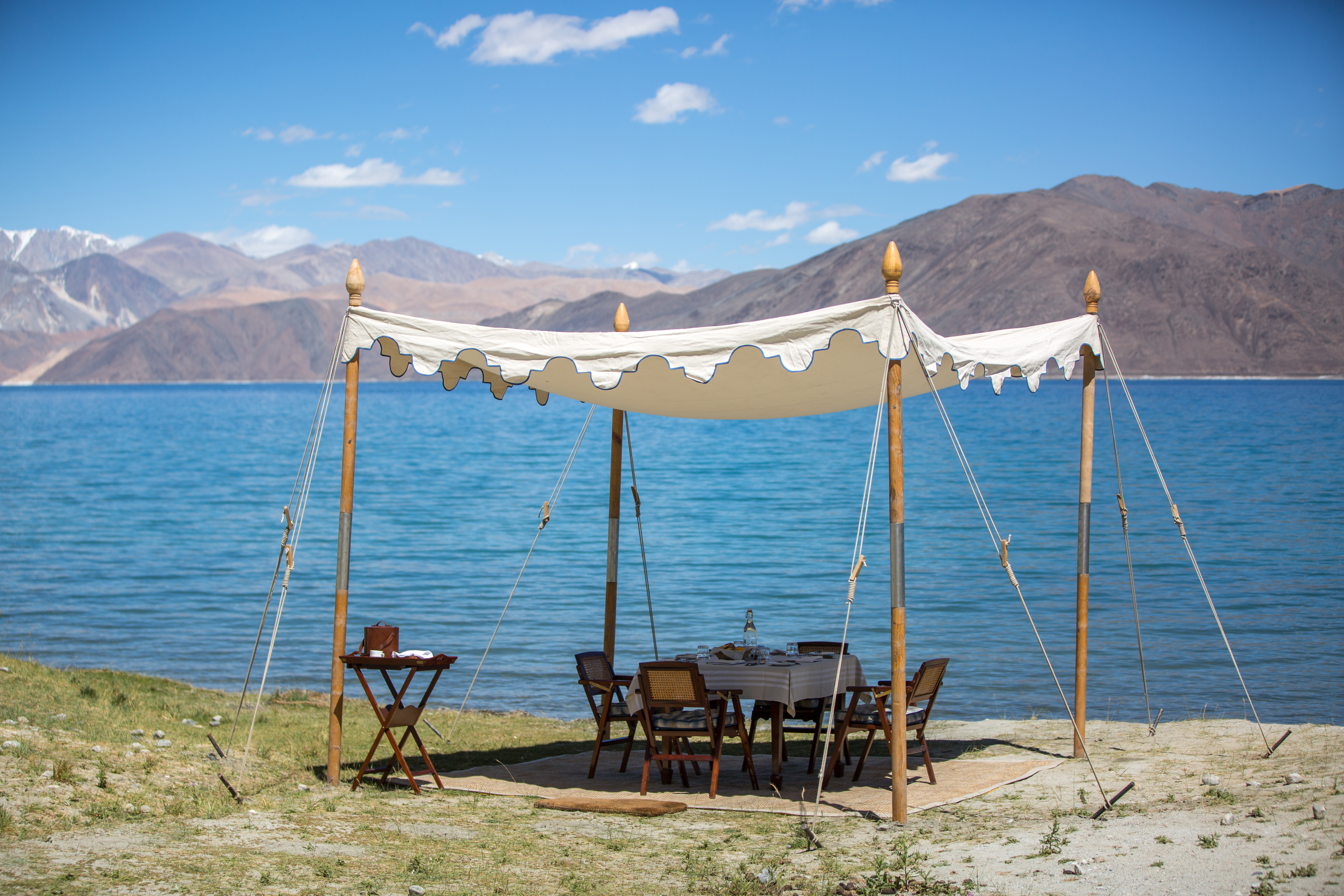 table set up outside by lake in Thiksey