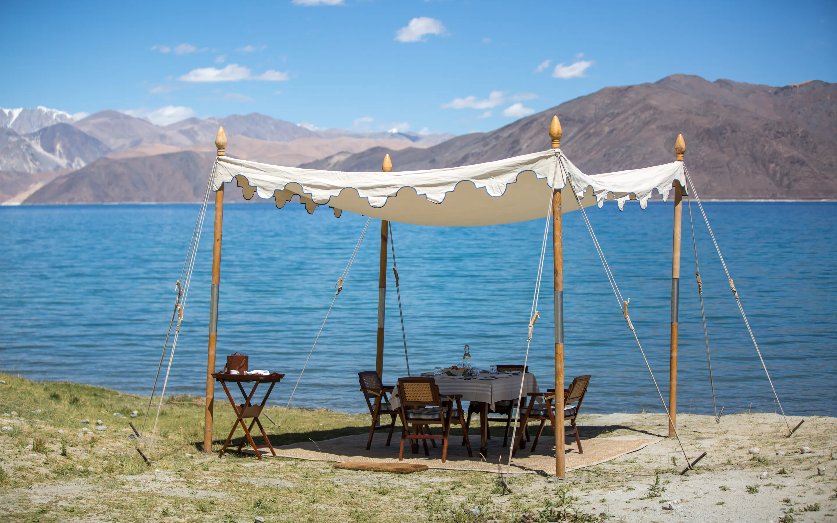 table set up outside by lake in Thiksey