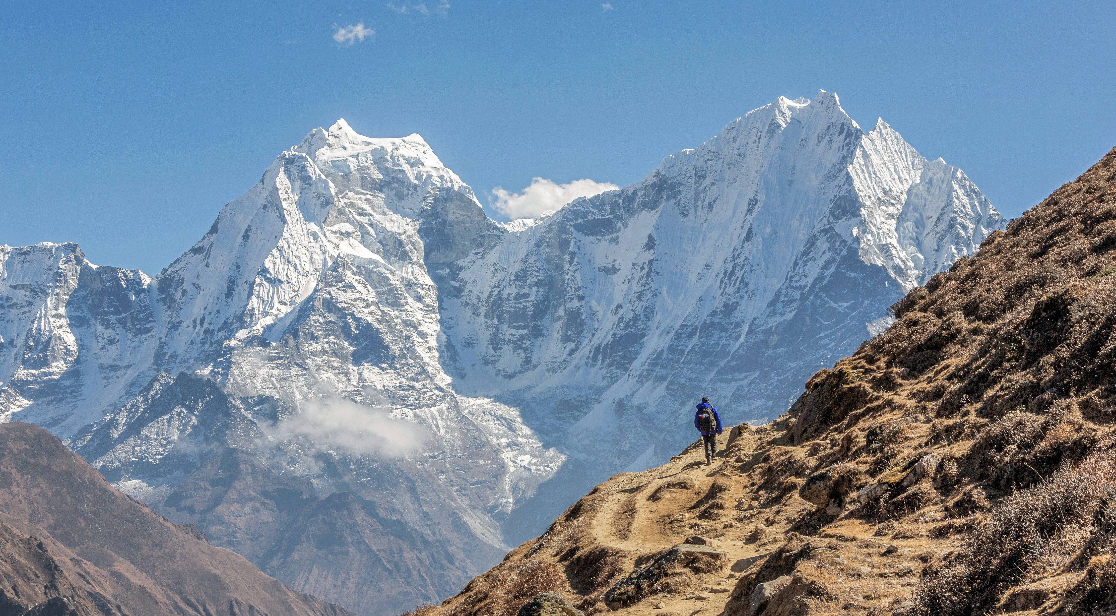 Tourist on the track. On the background of Khantega and Thamserky Peaks - Everest region, Nepal, Himalayas 