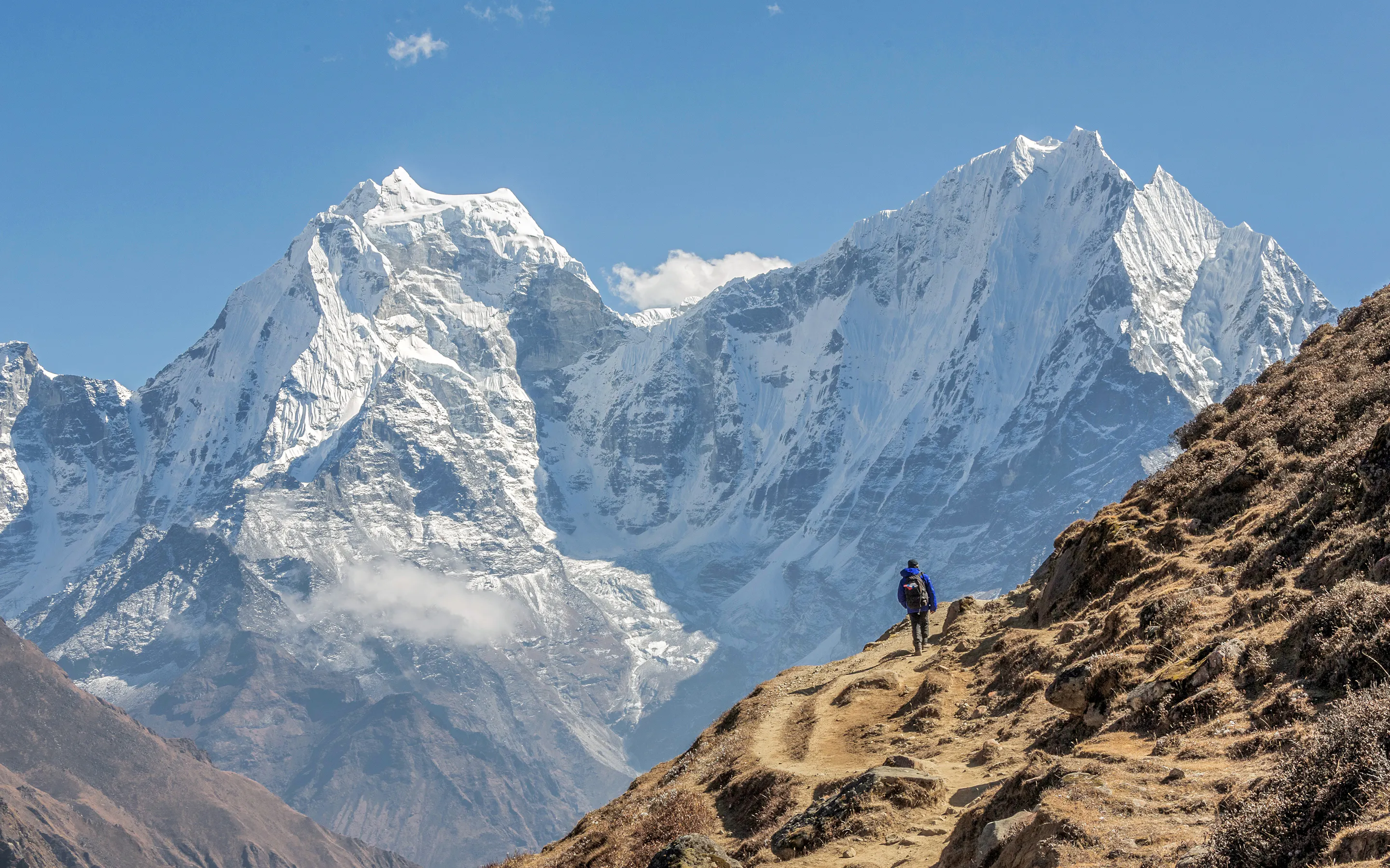 Tourist on the track. On the background of Khantega and Thamserky Peaks - Everest region, Nepal, Himalayas