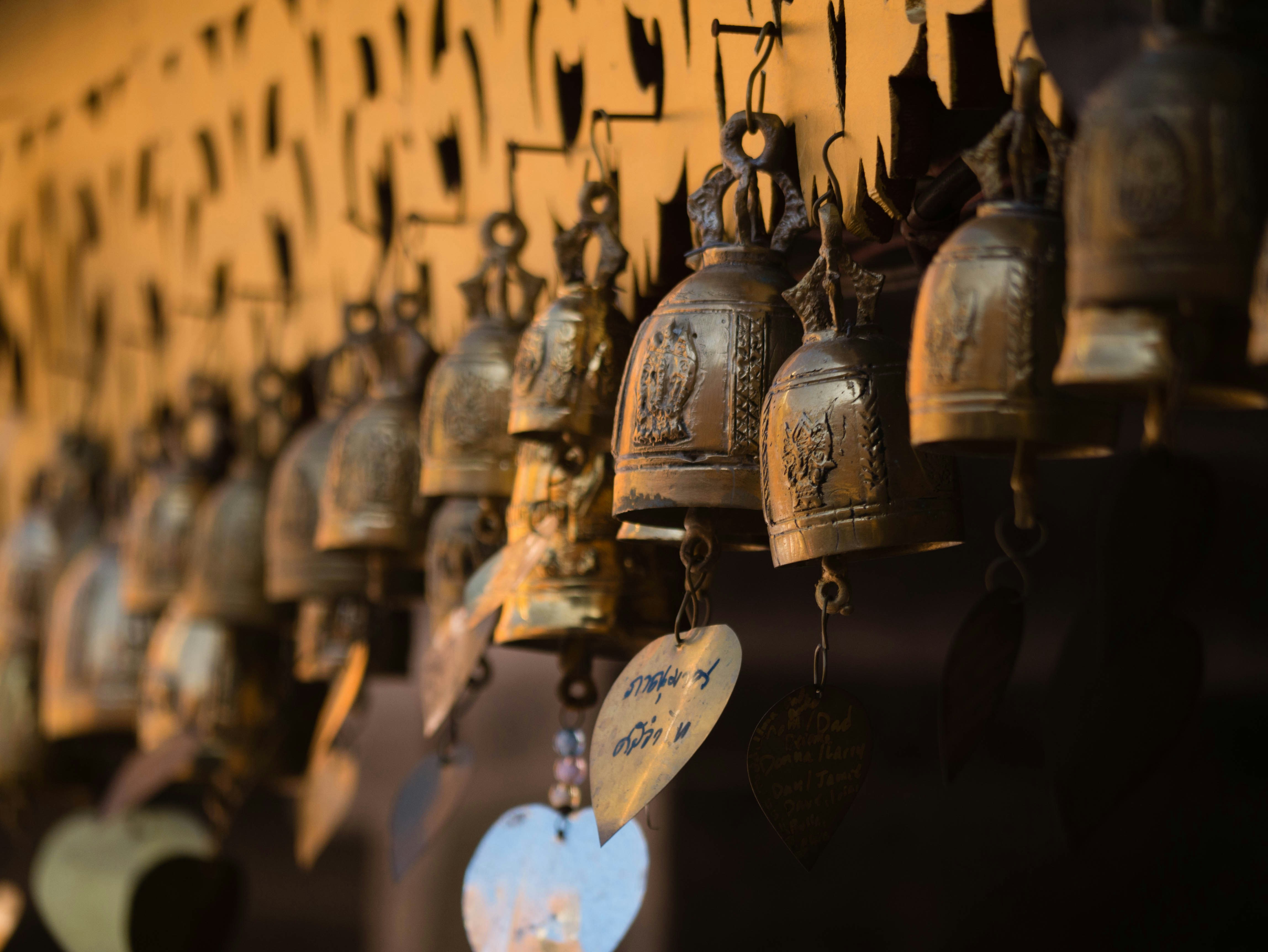 row of ornate Buddhist temple bells, which are commonly found in temples across