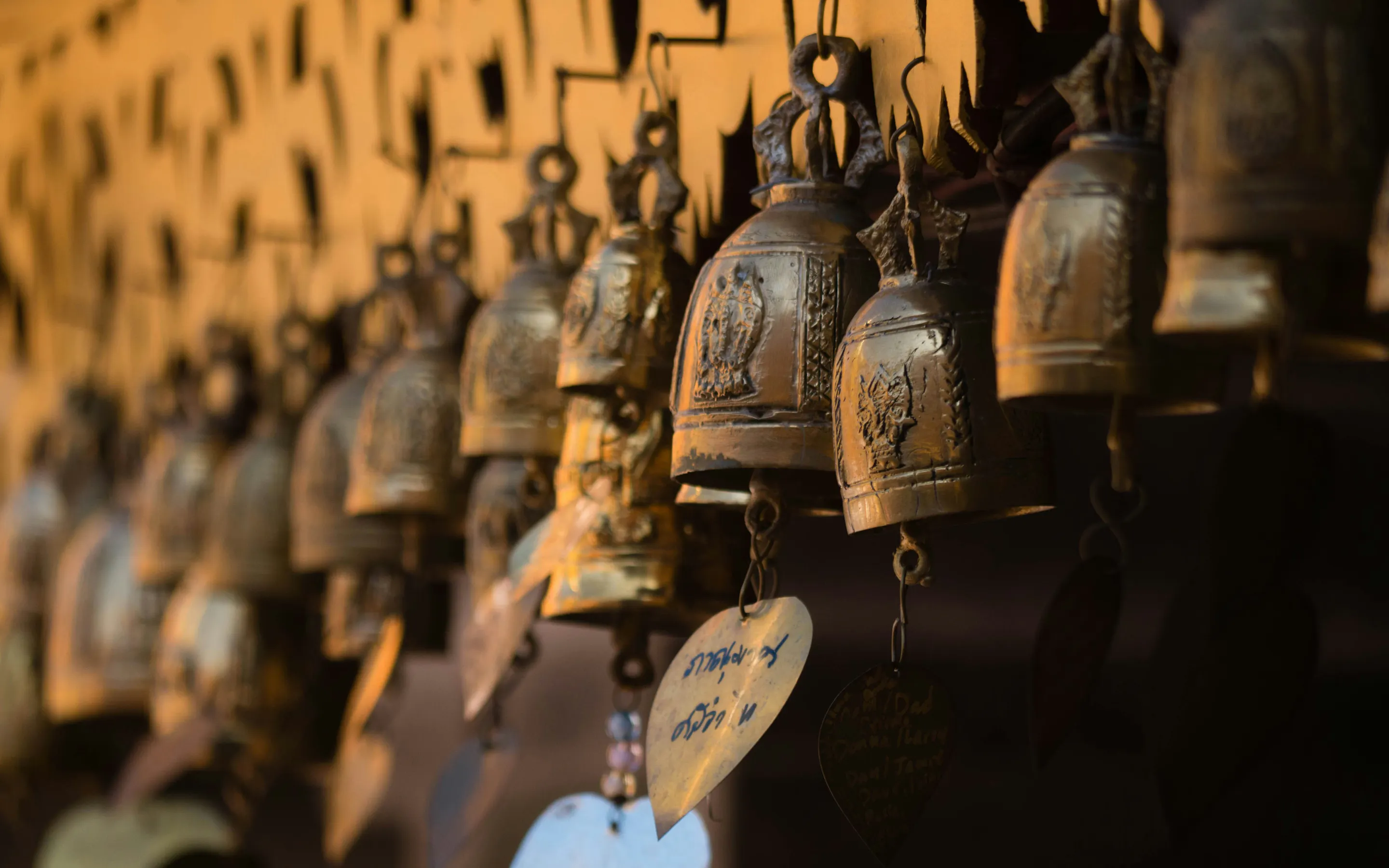 row of ornate Buddhist temple bells, which are commonly found in temples across
