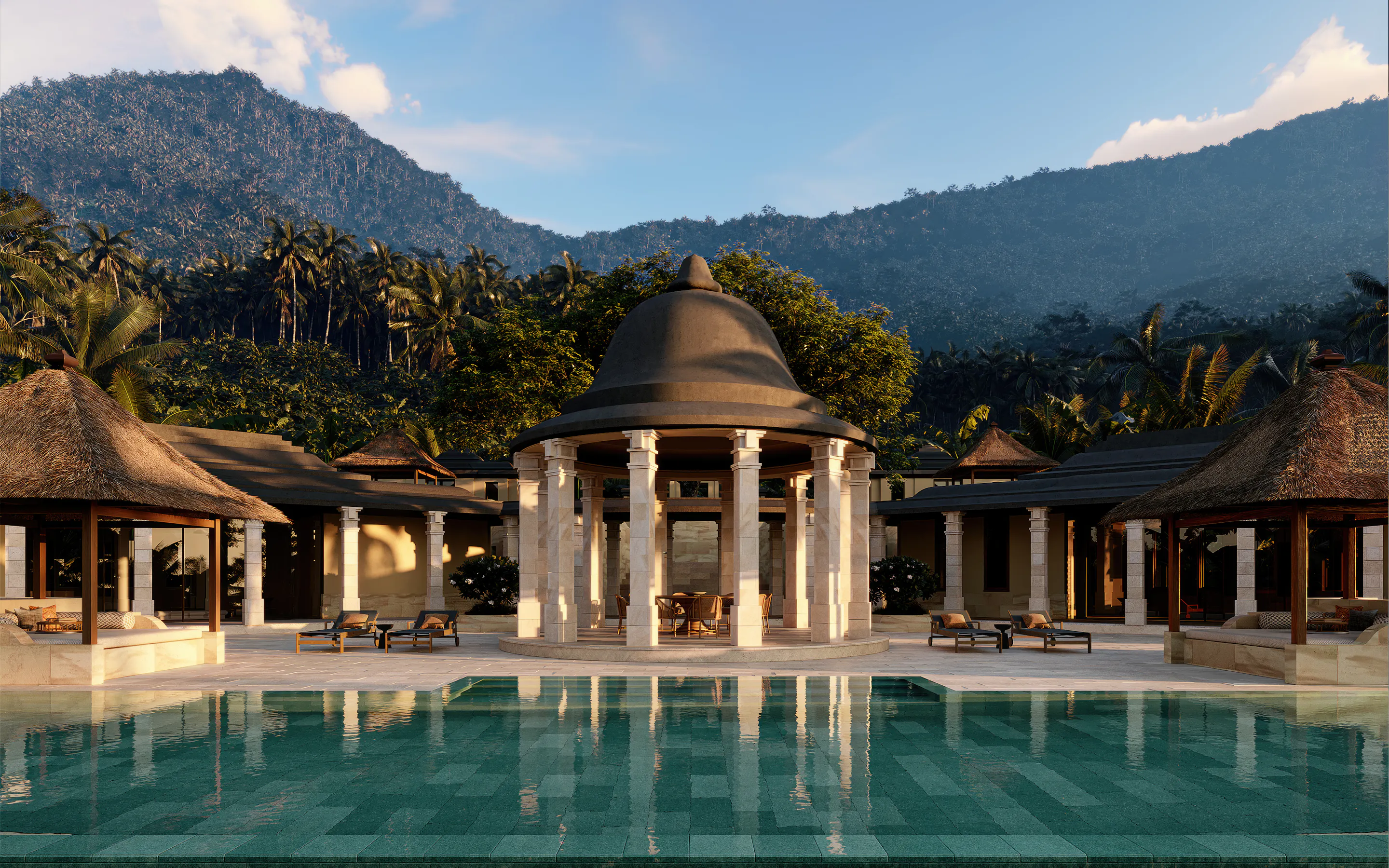 Amanjiwo's stone pavilion rises beyond a long pool, with forested hills and palm-lined slopes behind the residence.