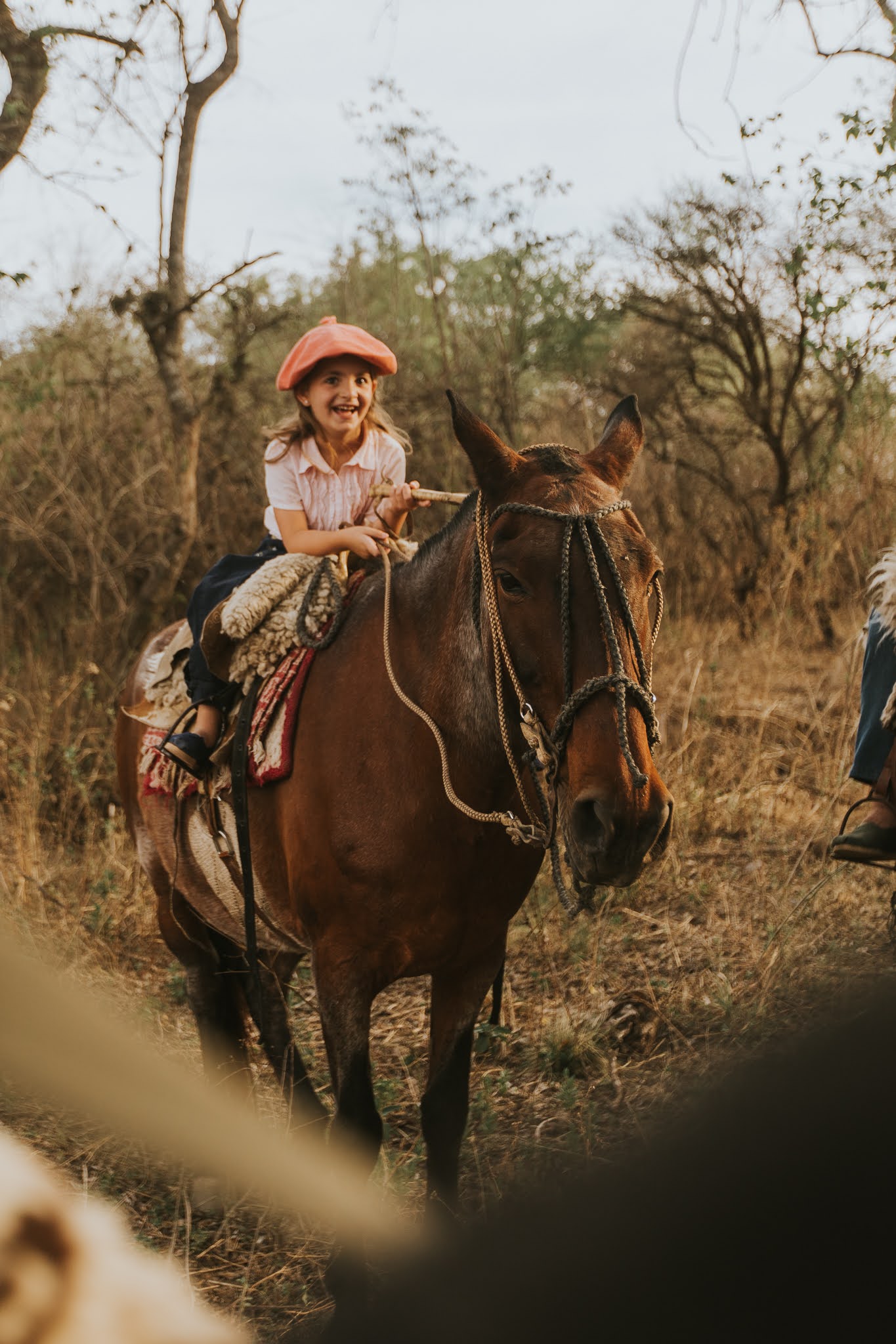 girl riding a horse and laughing in Argentina
