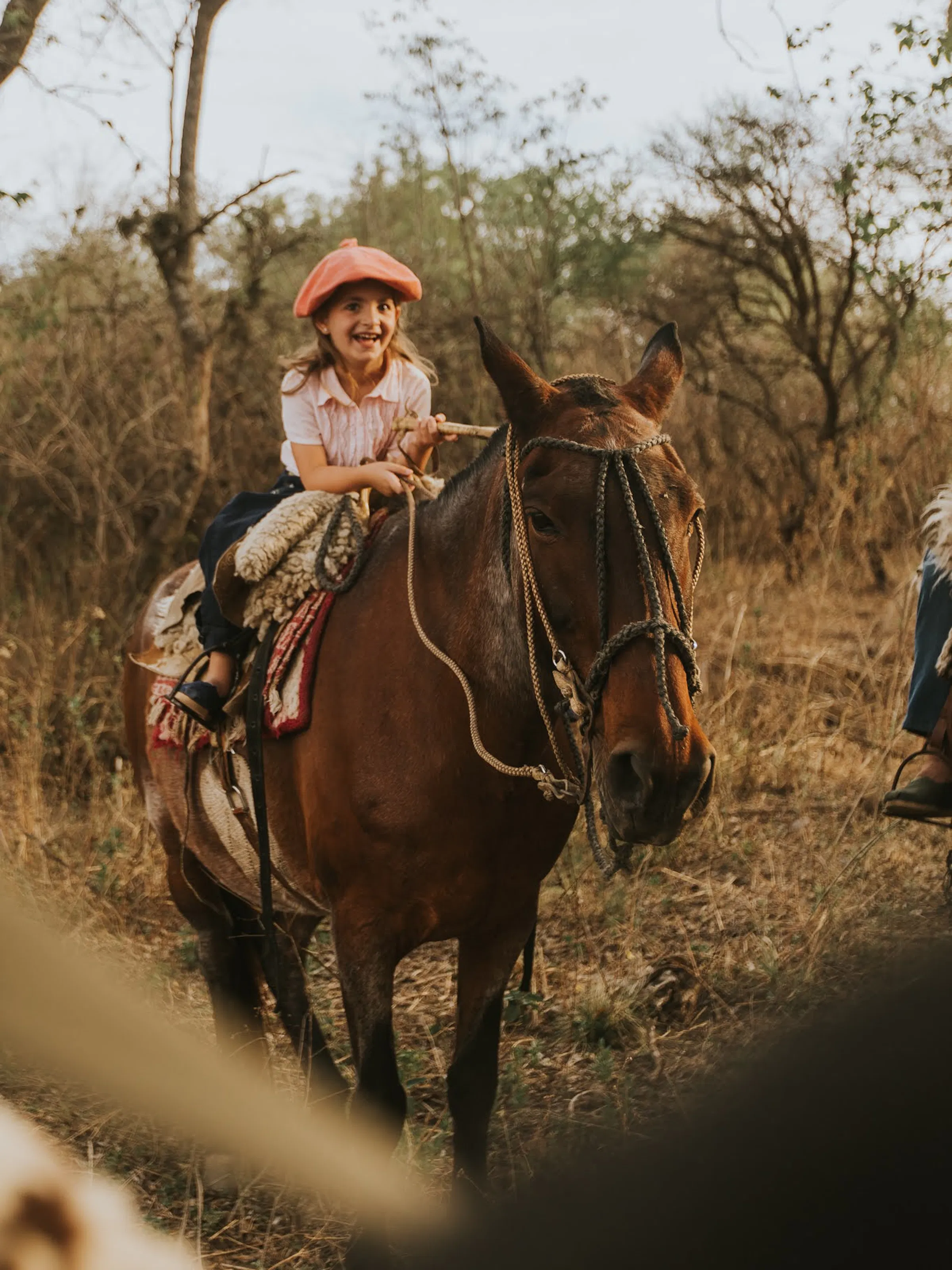 girl riding a horse and laughing in Argentina