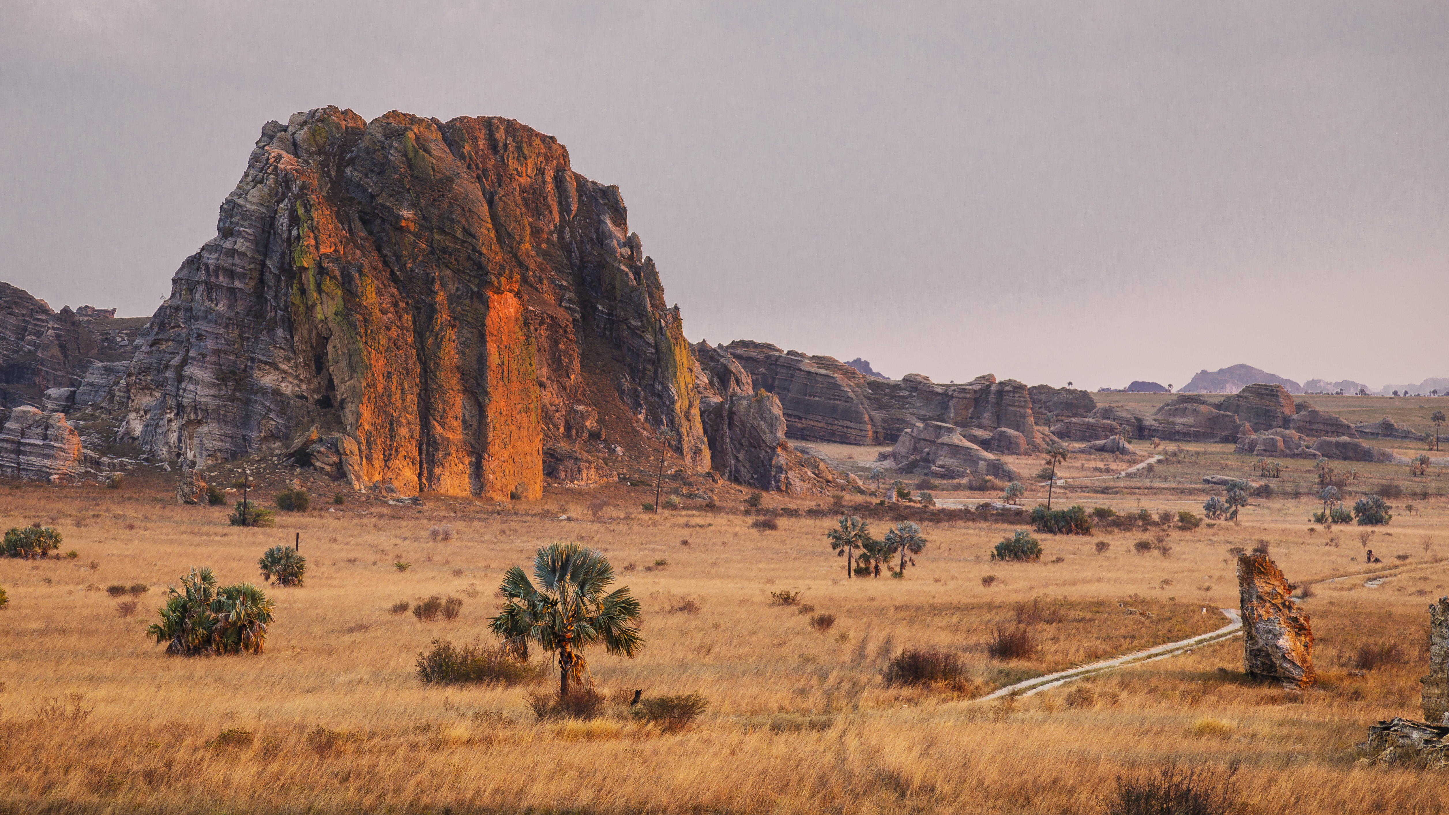 Warm sunset light bathes the dramatic sandstone formations of Isalo National Park, Madagascar.