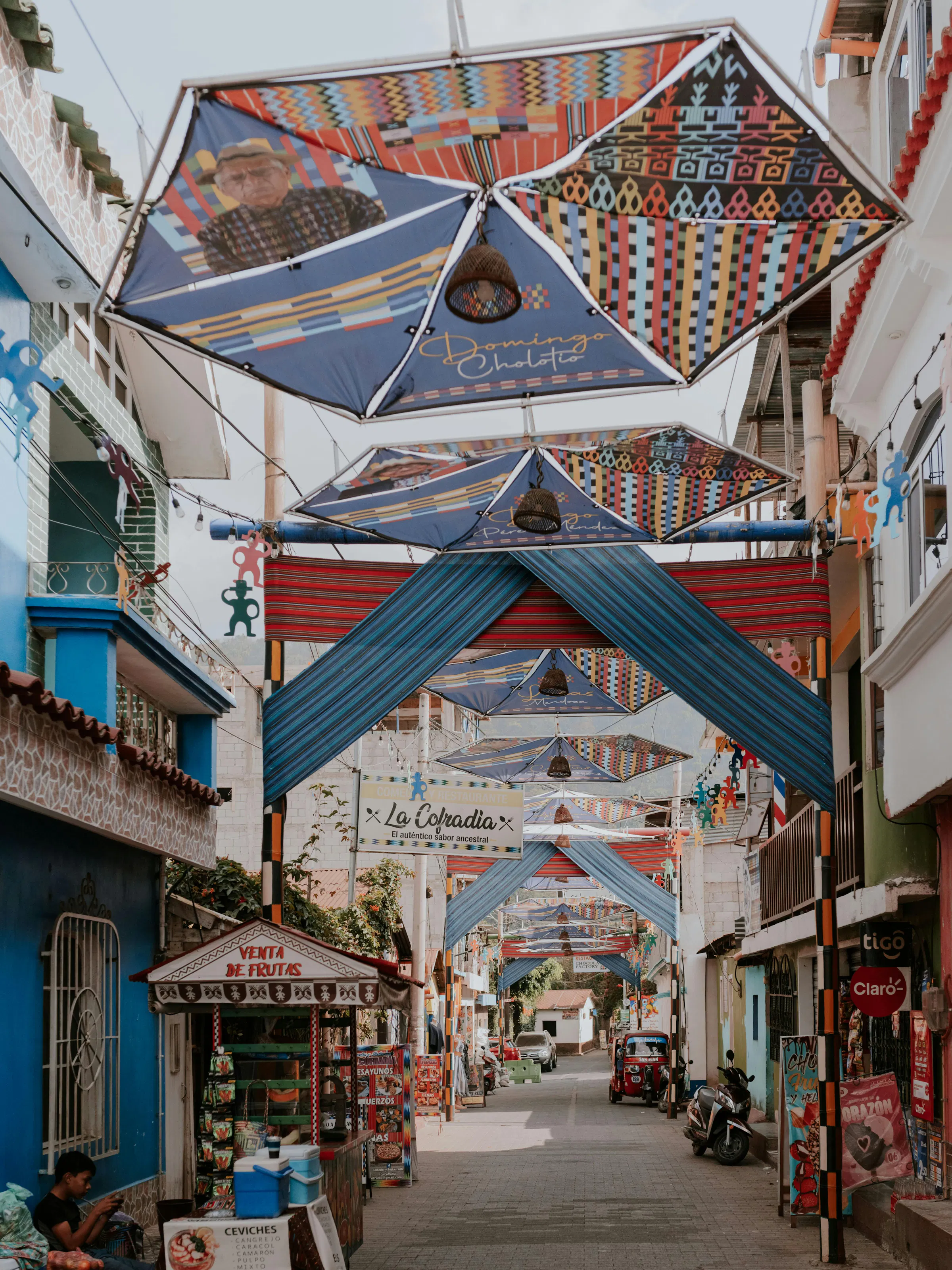 A colorful painted market hall with a patterned ceiling is lined with stalls in Santa Marta.