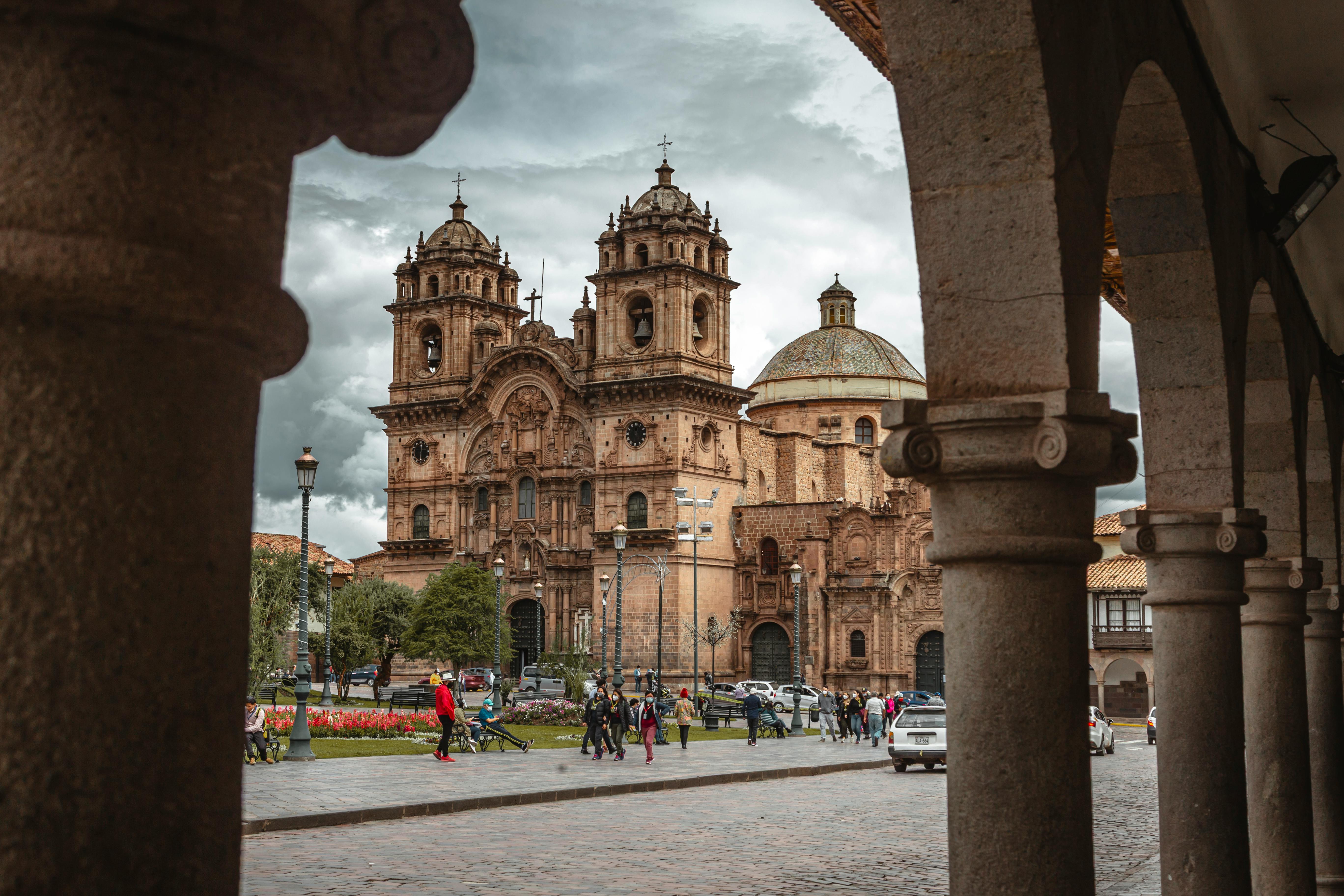 The ornate Baroque facade of Cusco Cathedral faces the wide cobblestone Plaza de Armas.
