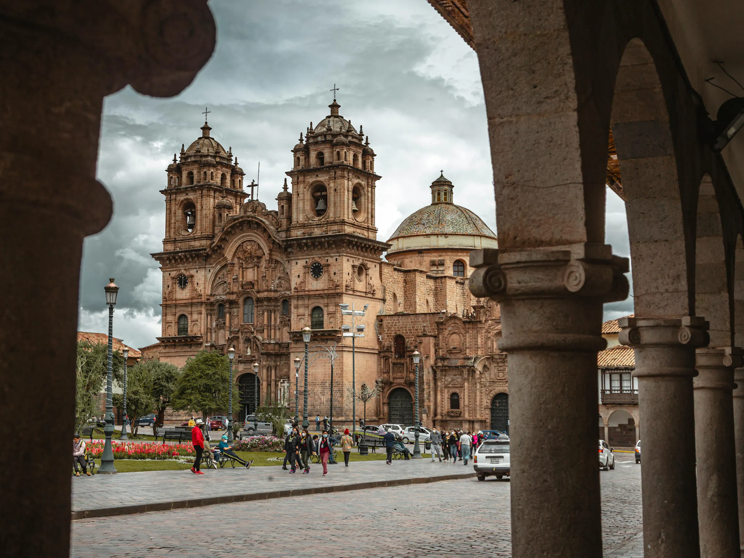 The ornate Baroque facade of Cusco Cathedral faces the wide cobblestone Plaza de Armas.