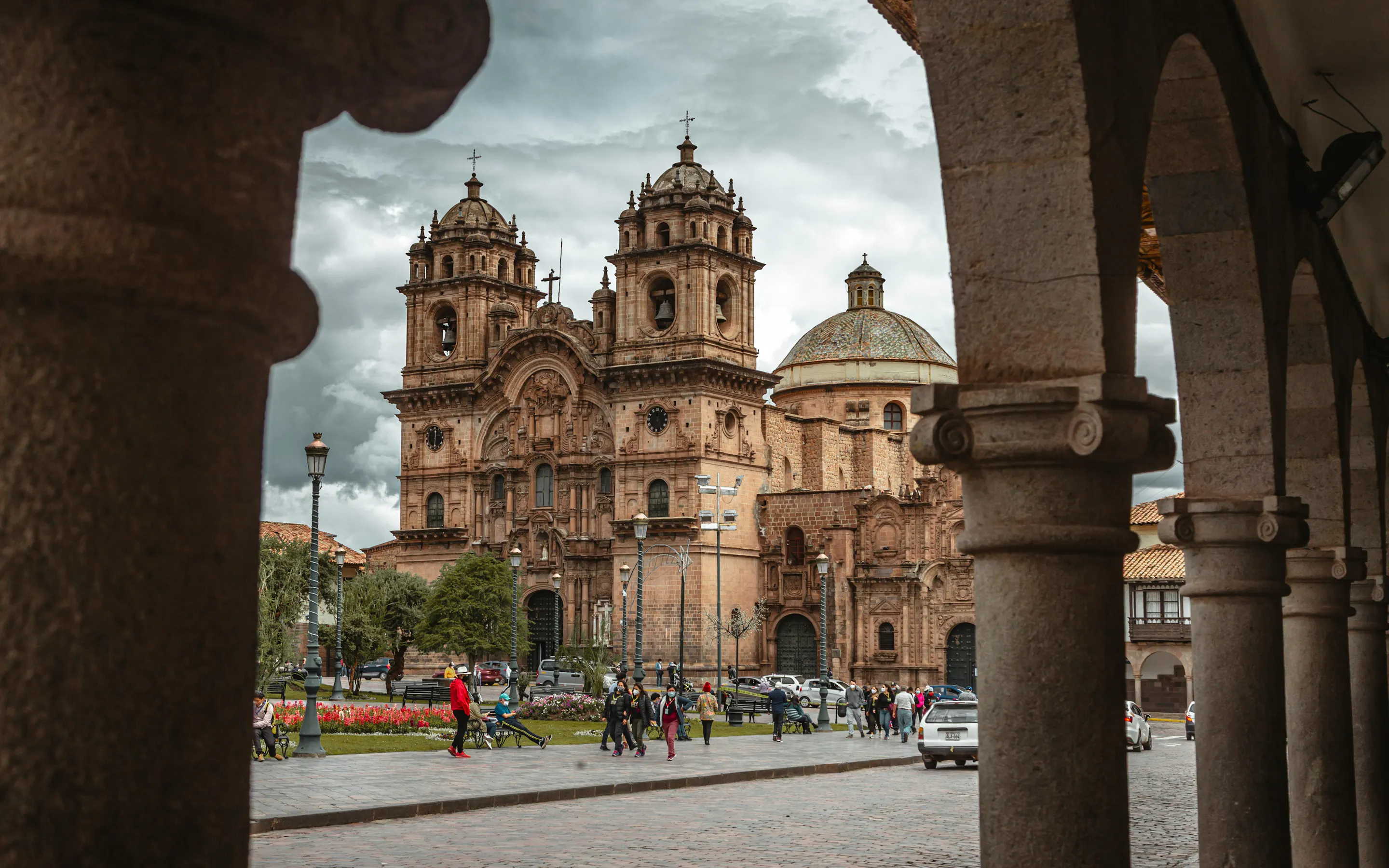 The ornate Baroque facade of Cusco Cathedral faces the wide cobblestone Plaza de Armas.
