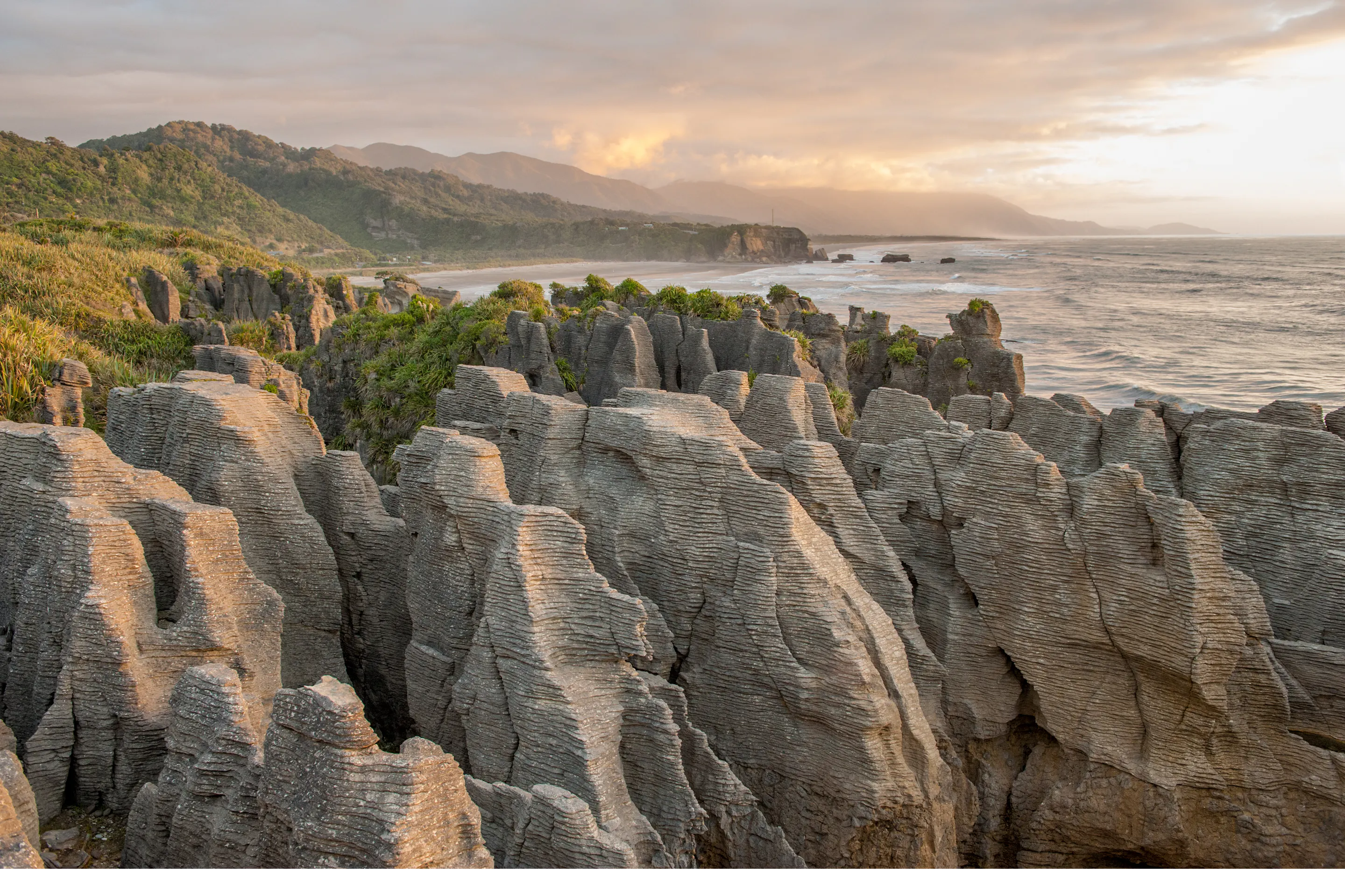 Layered pancake rock formations rise from the Tasman Sea at Punakaiki on New Zealand's West Coast.