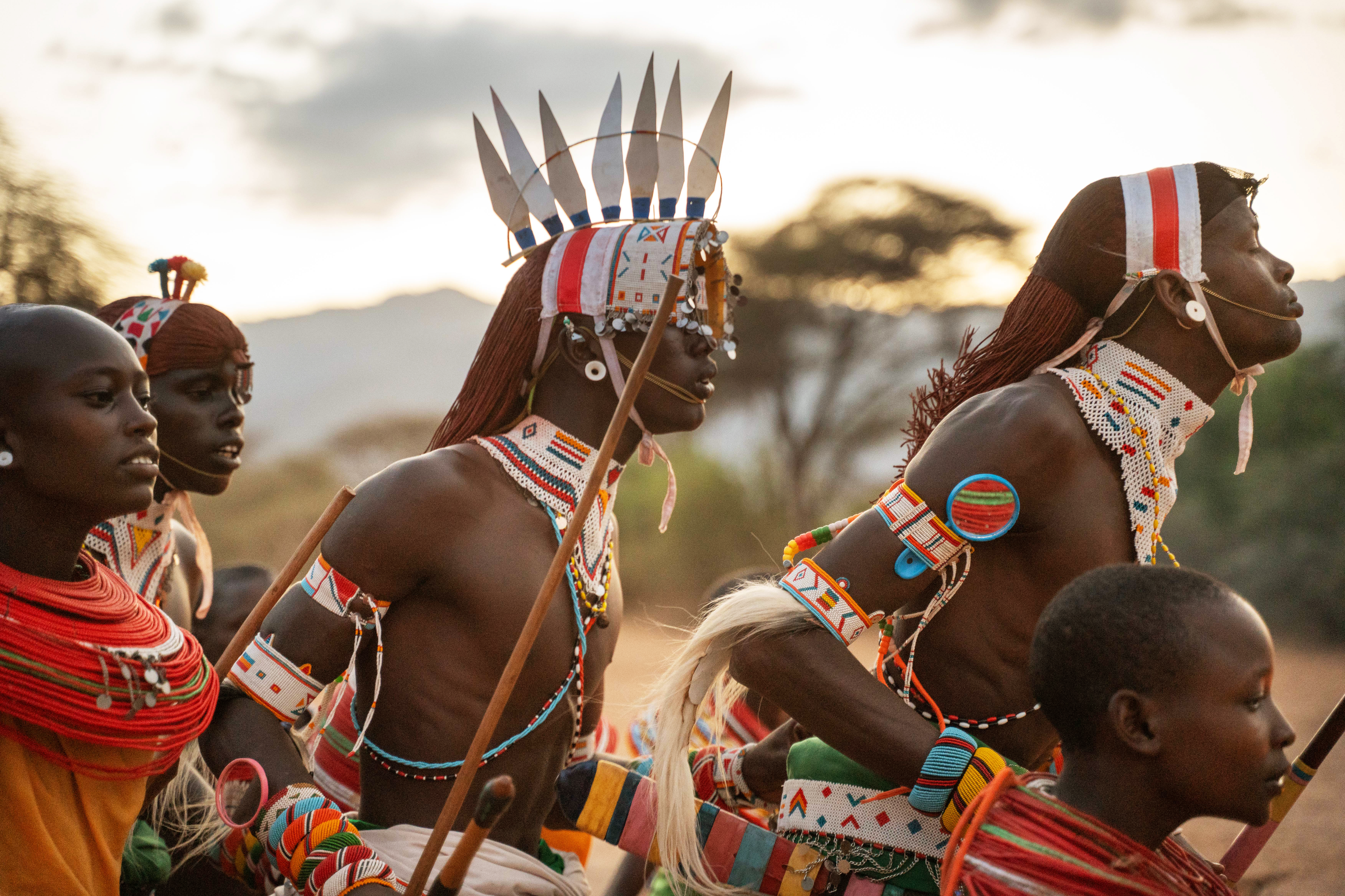 Samburu warriors in traditional red beaded dress perform a ceremonial dance in Kenya's Matthews Range.