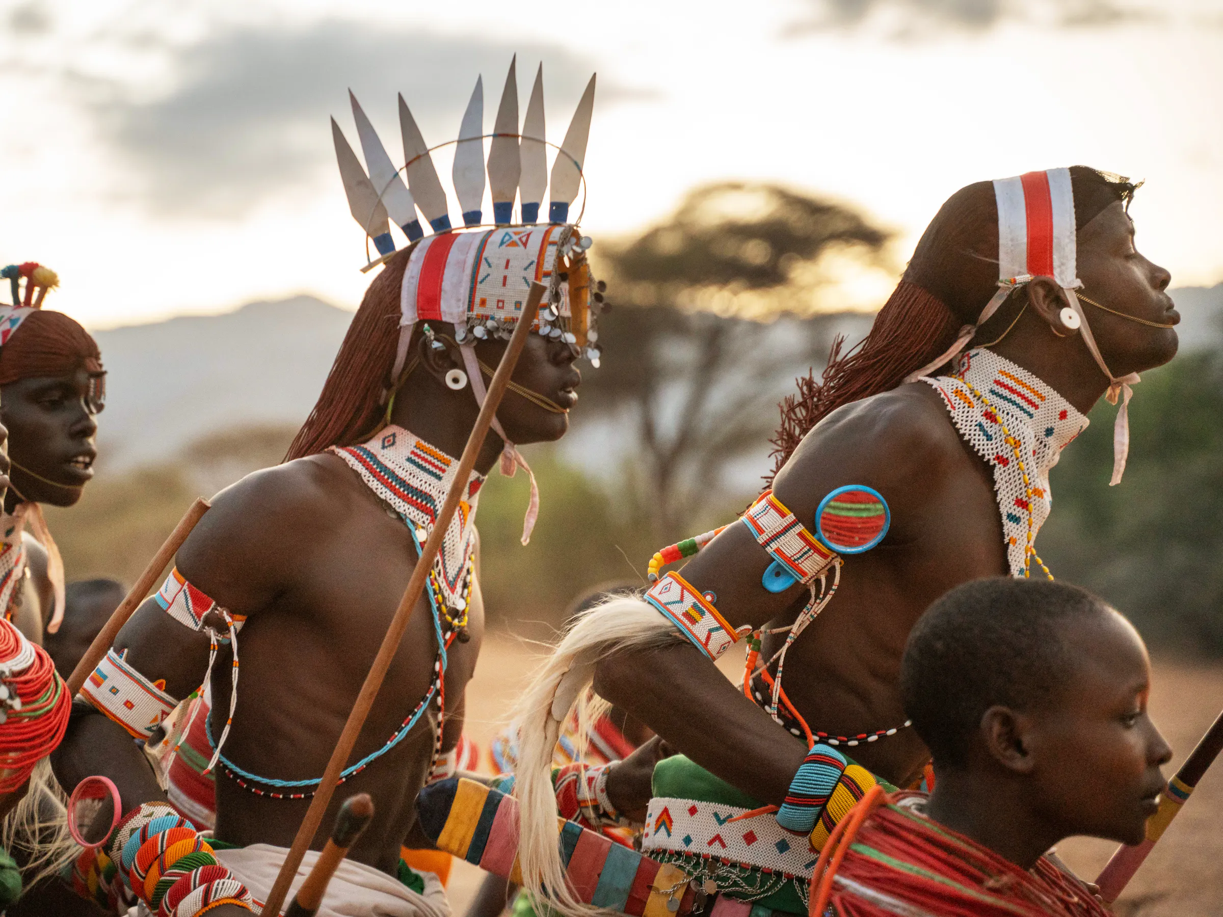 Samburu warriors in traditional red beaded dress perform a ceremonial dance in Kenya's Matthews Range.