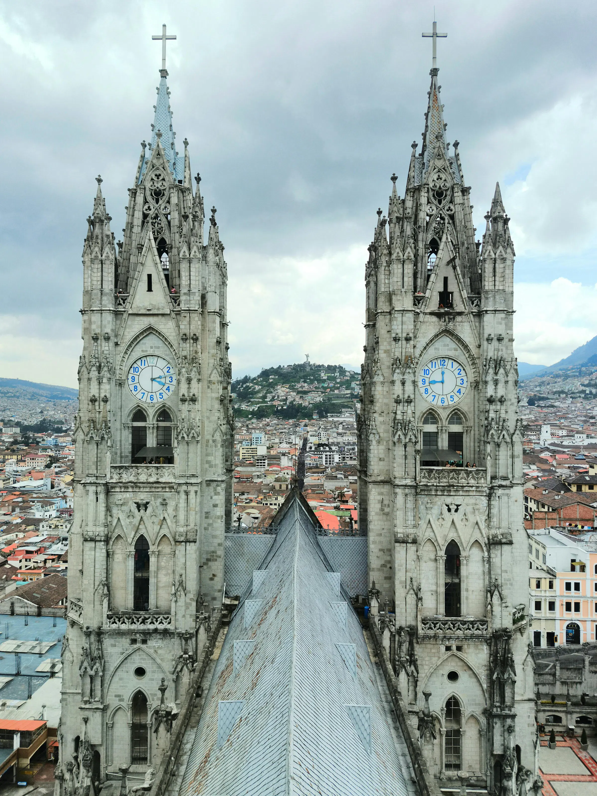 The towering neo-Gothic spires of the Basílica del Voto Nacional rise above Quito's historic center.
