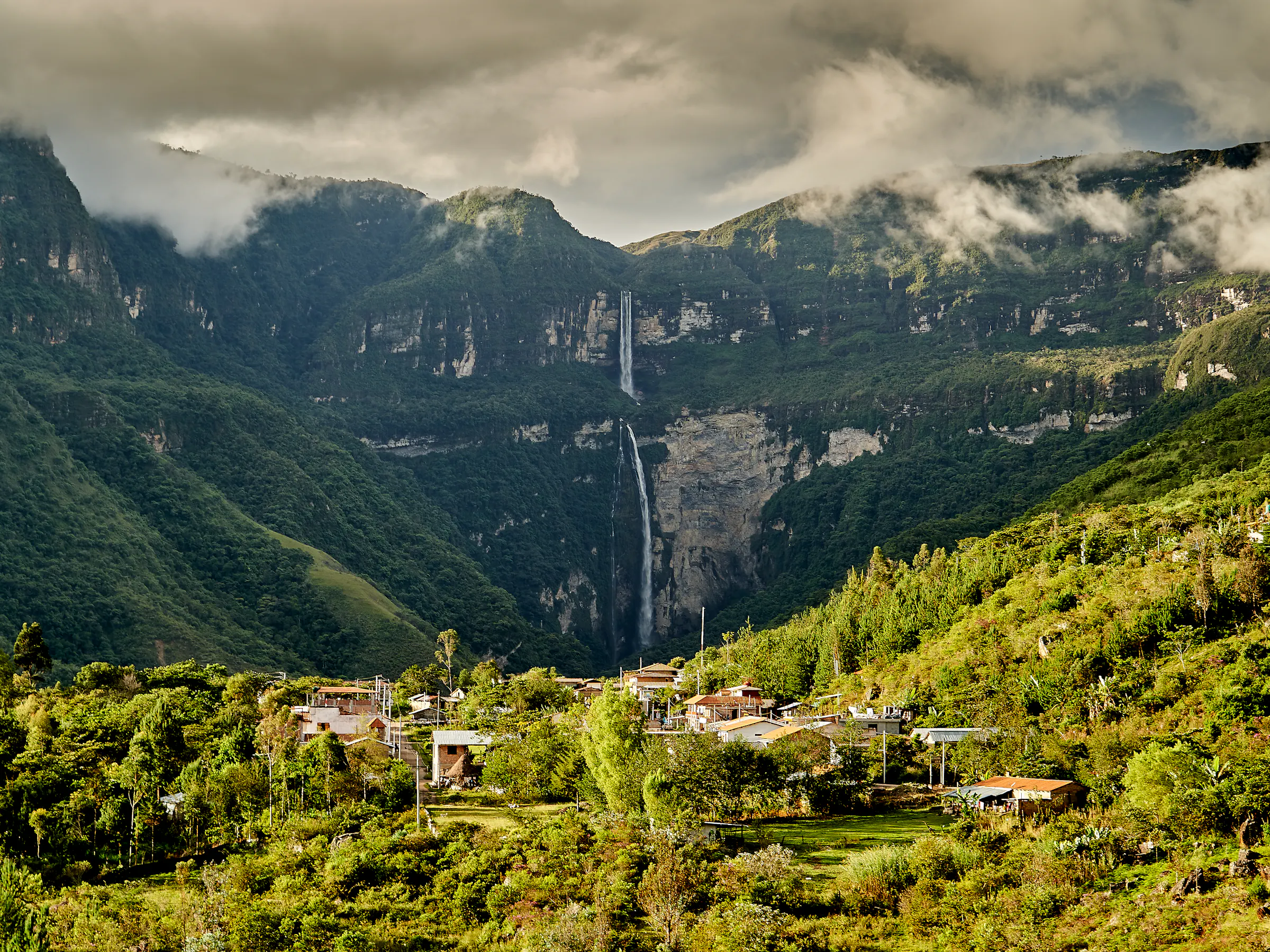 The Gocta waterfall plunges in two long cascades down a green cliff into the Amazon jungle.