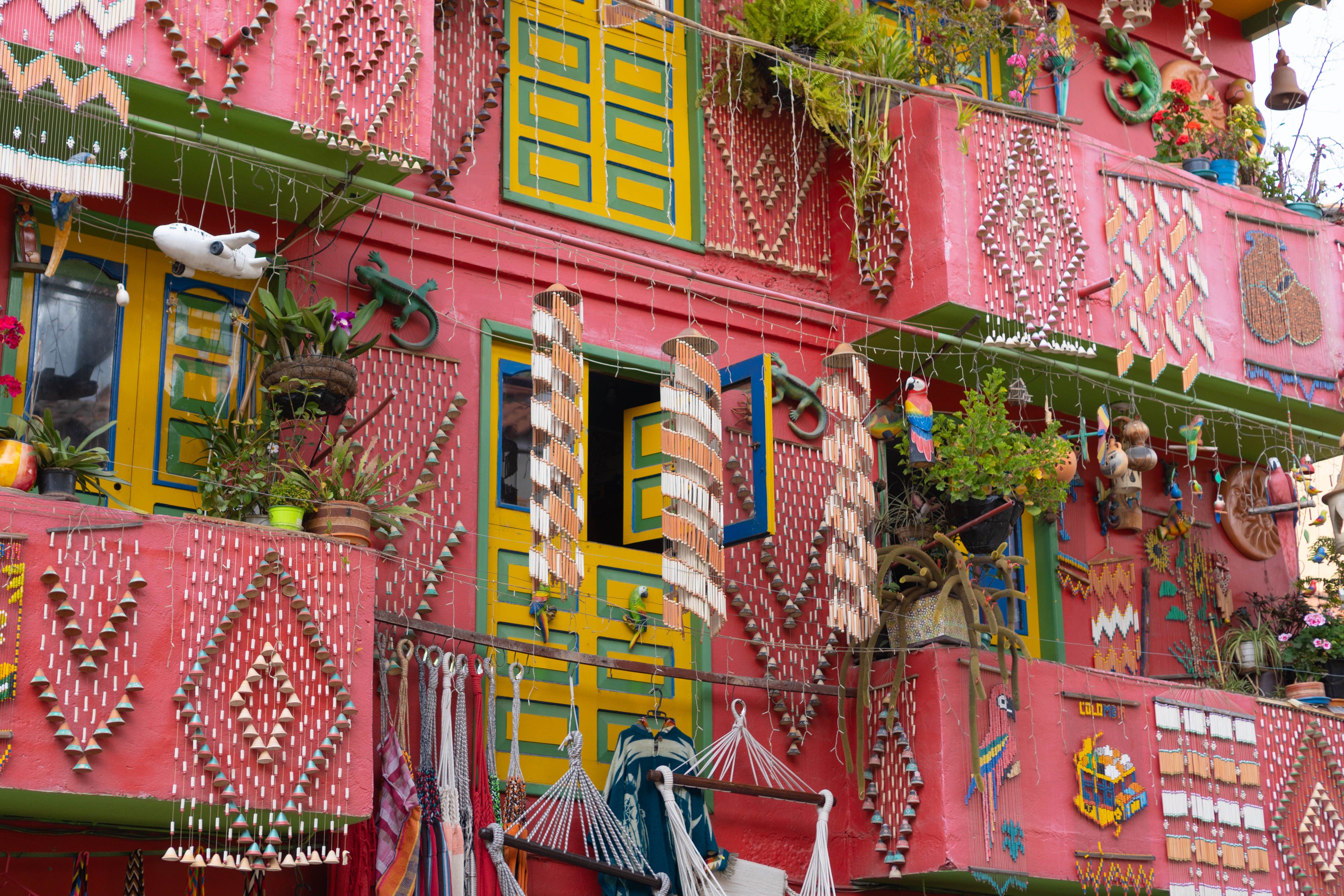 Brightly painted balconies draped in textiles and rugs line a vibrant street in Villa de Leyva.