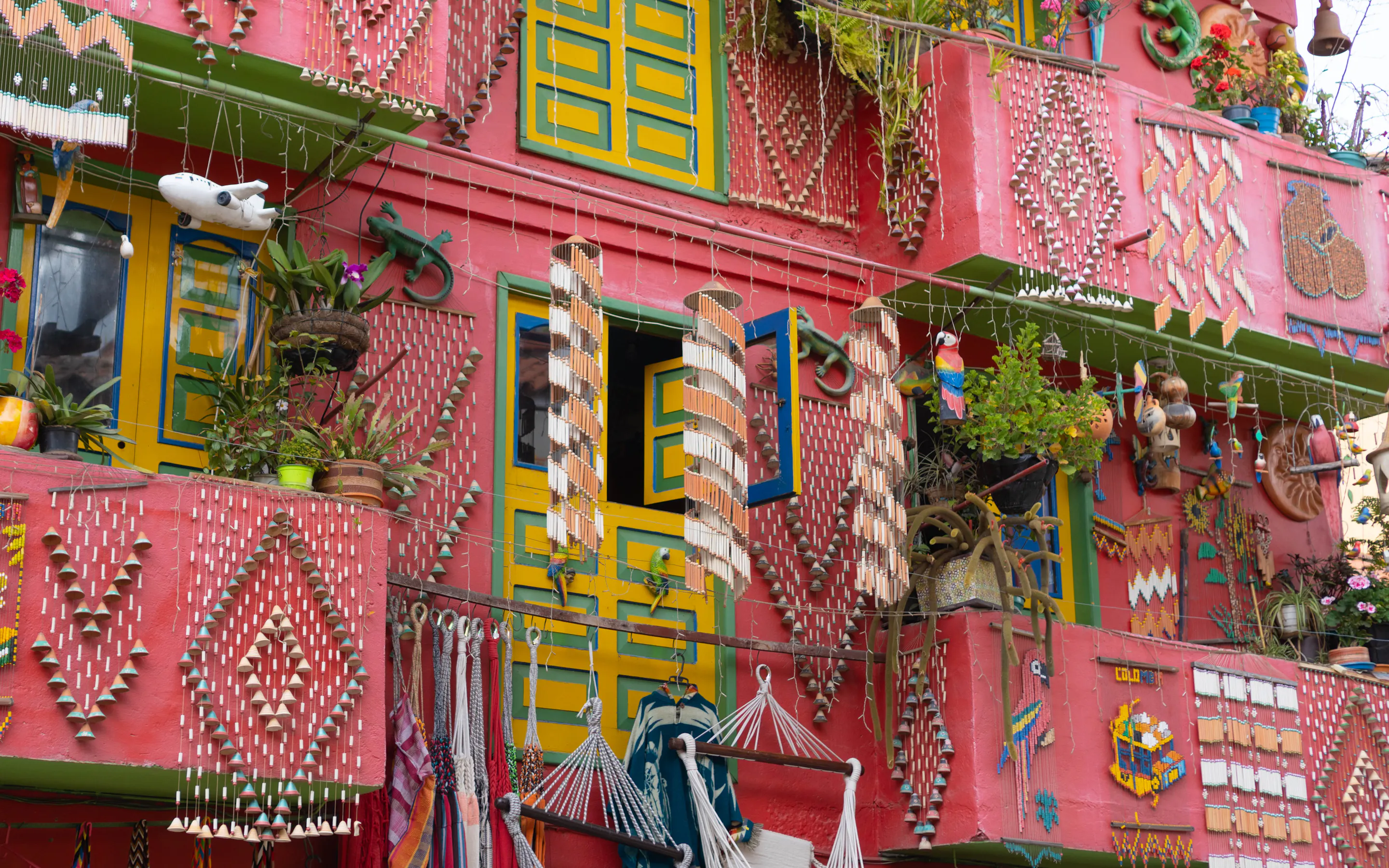 Brightly painted balconies draped in textiles and rugs line a vibrant street in Villa de Leyva.