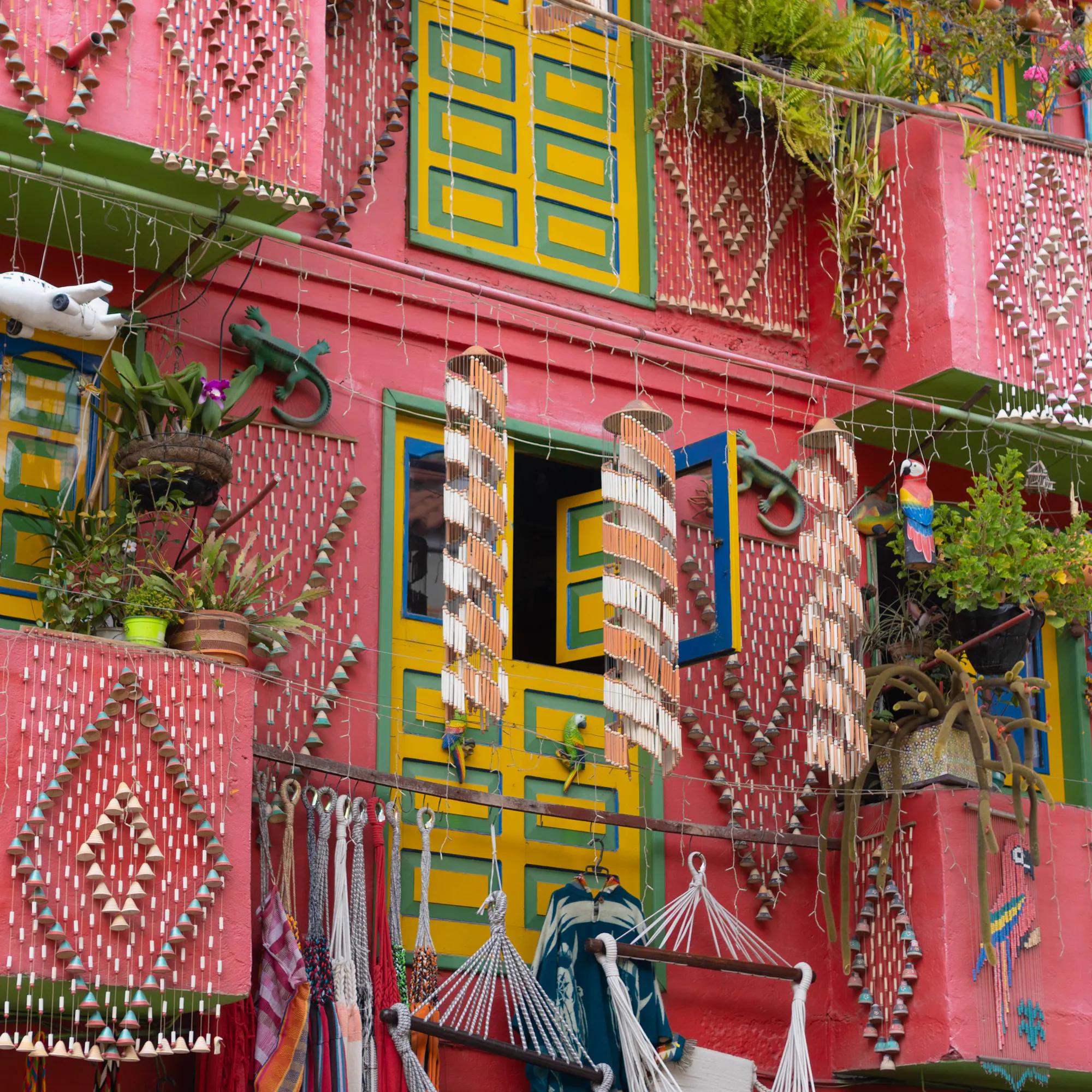 Brightly painted balconies draped in textiles and rugs line a vibrant street in Villa de Leyva.