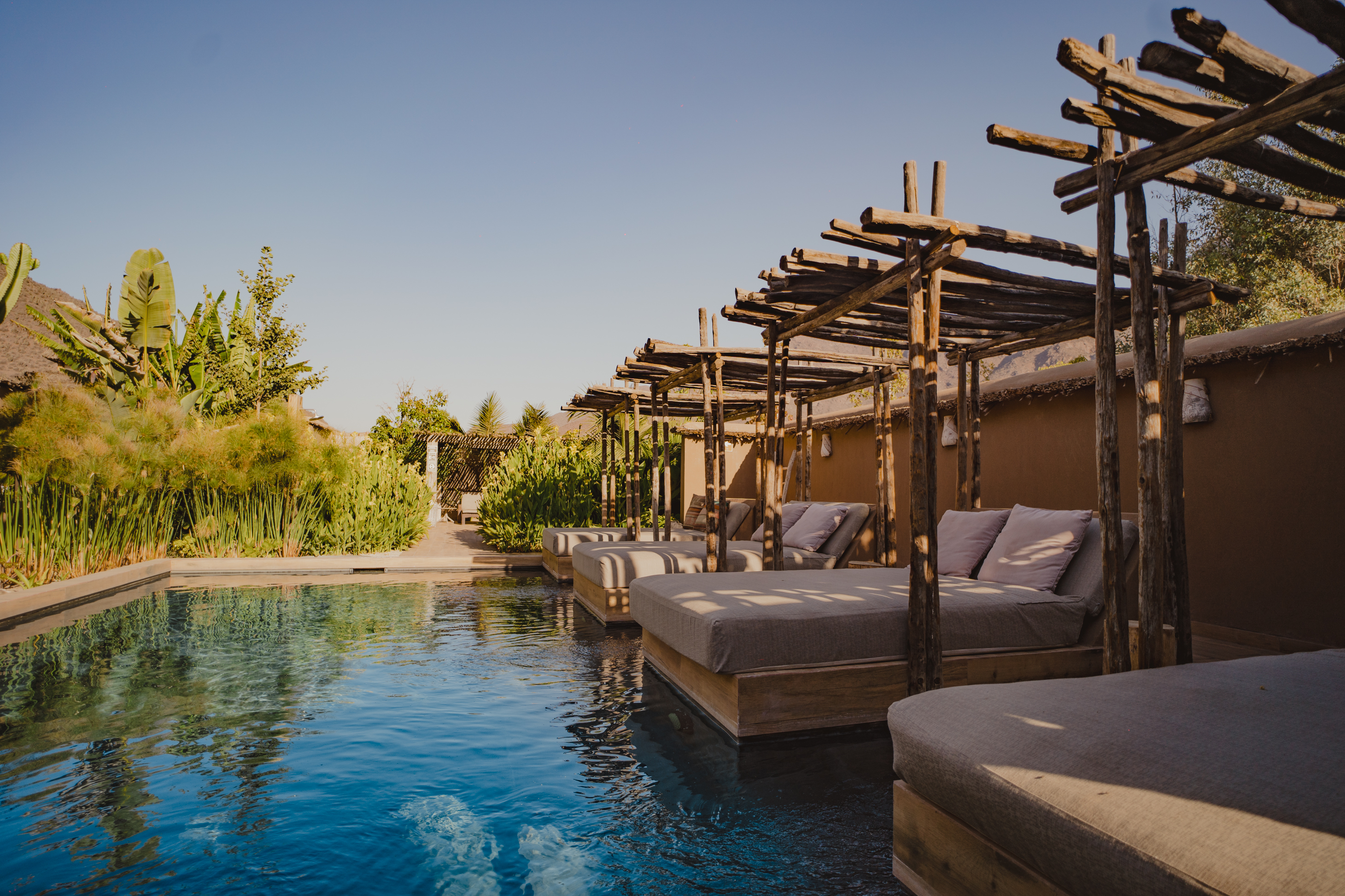 A sleek infinity pool reflects a mountain ridgeline at a boutique lodge in Chile's Elqui Valley.