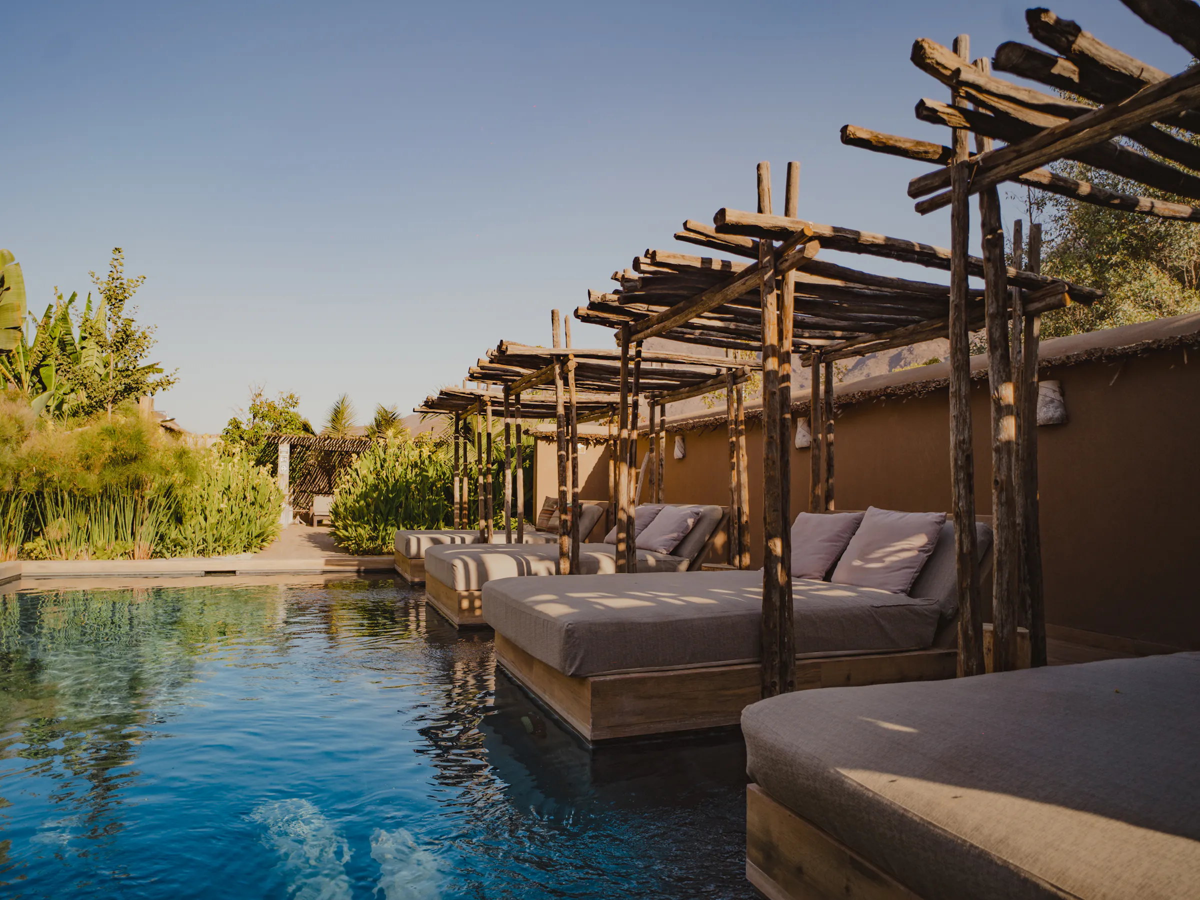 A sleek infinity pool reflects a mountain ridgeline at a boutique lodge in Chile's Elqui Valley.