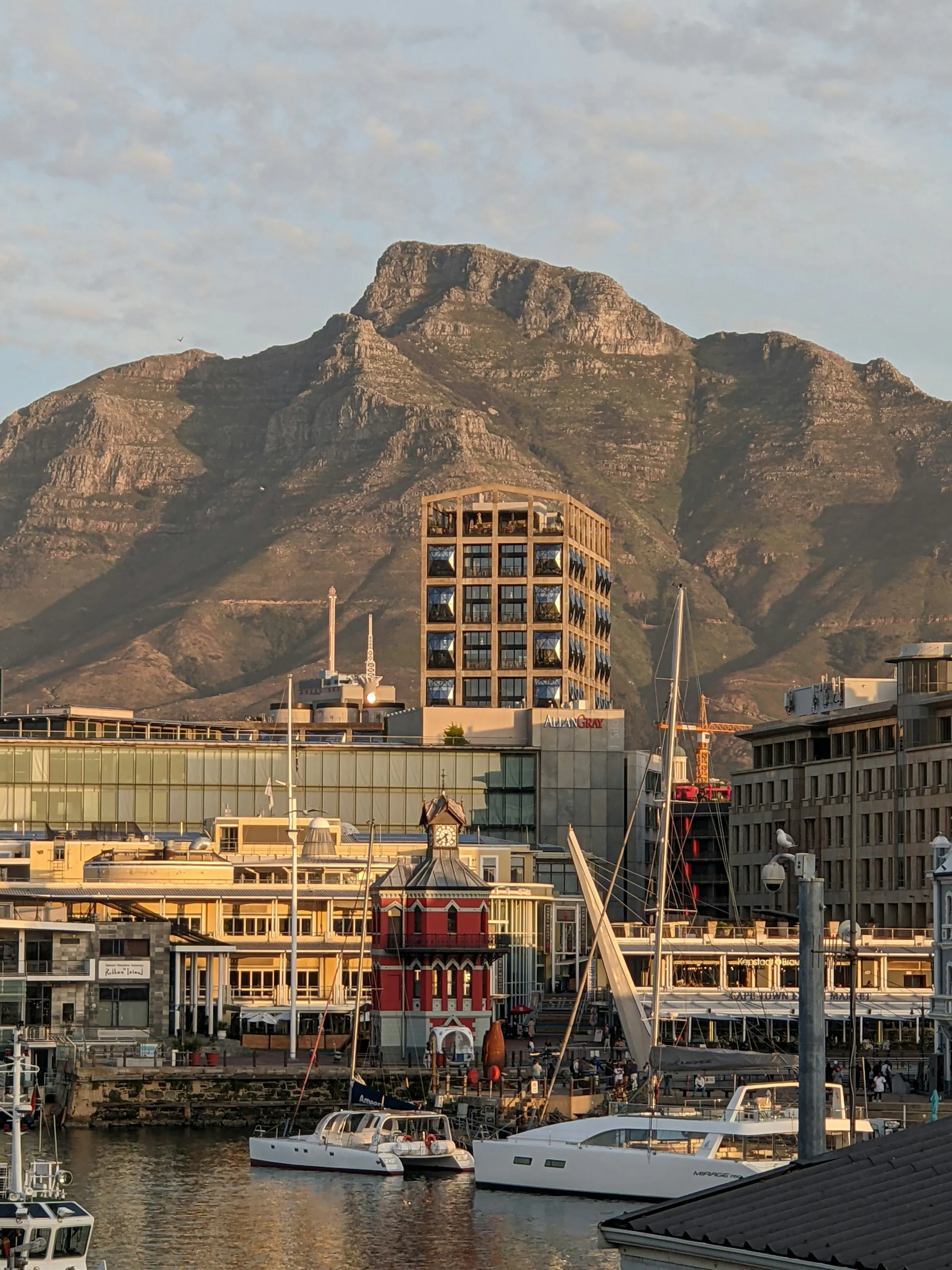 view from marina with boats and mountains in background
