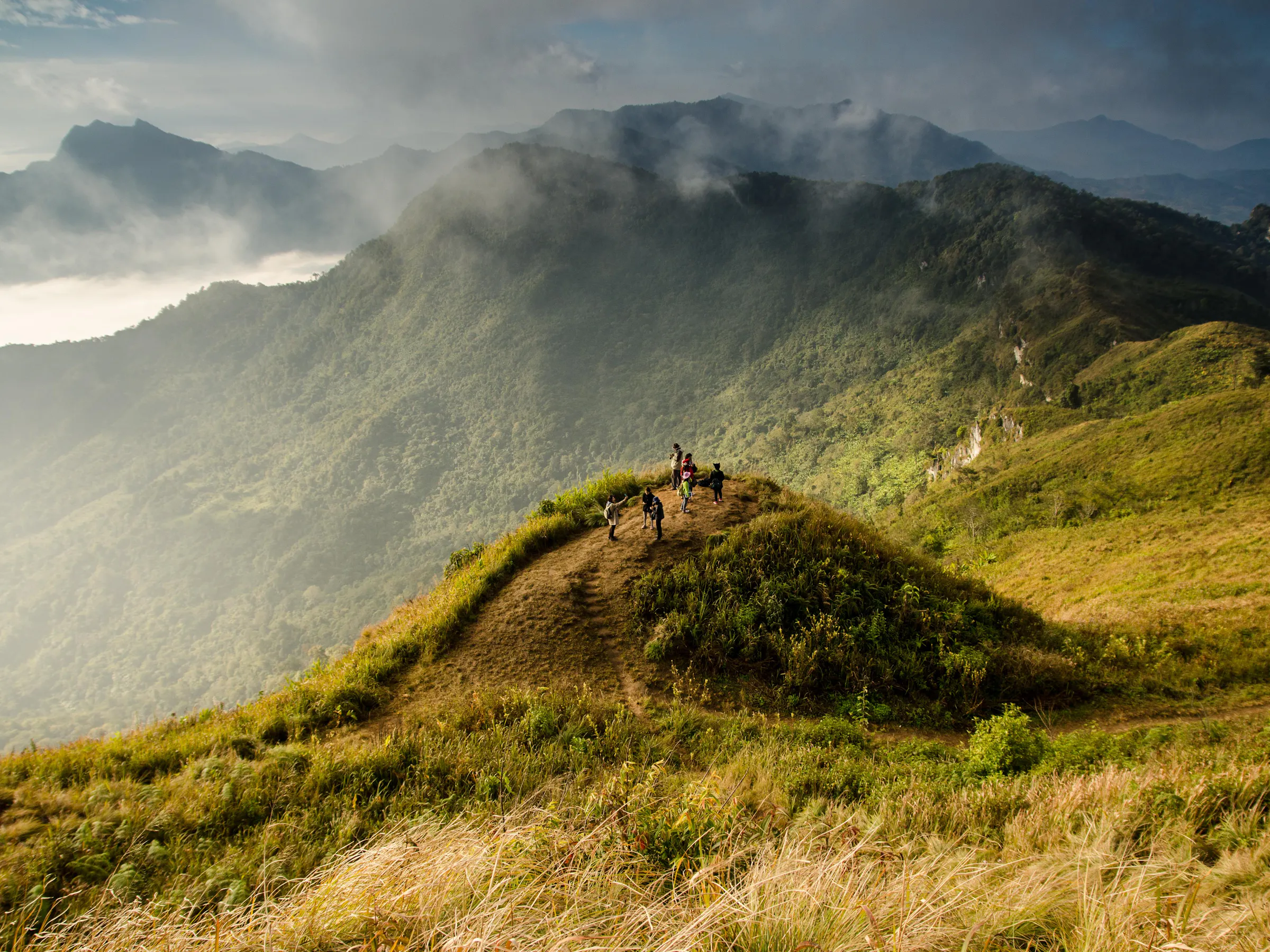 Hikers on a misty mountain ridge overlooking Valle de Antón, Panama