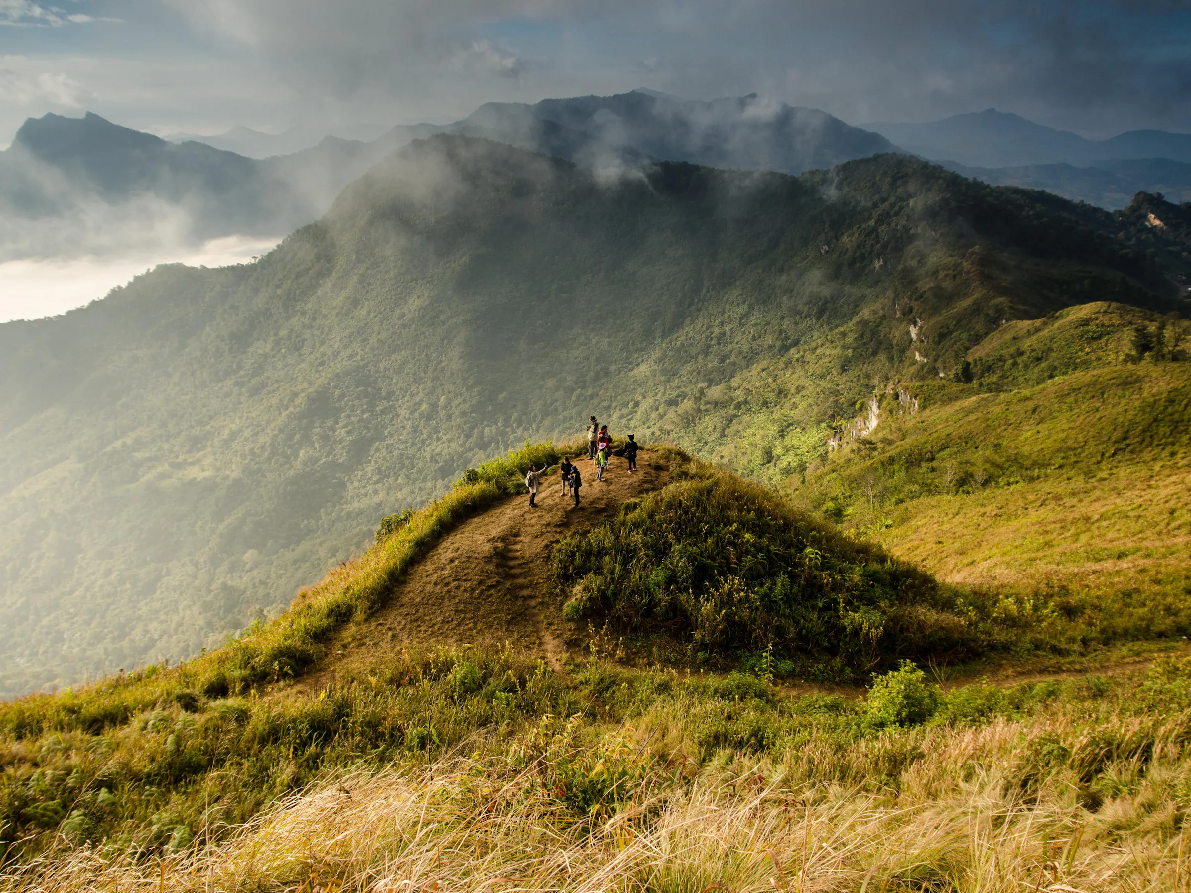Hikers on a misty mountain ridge overlooking Valle de Antón, Panama