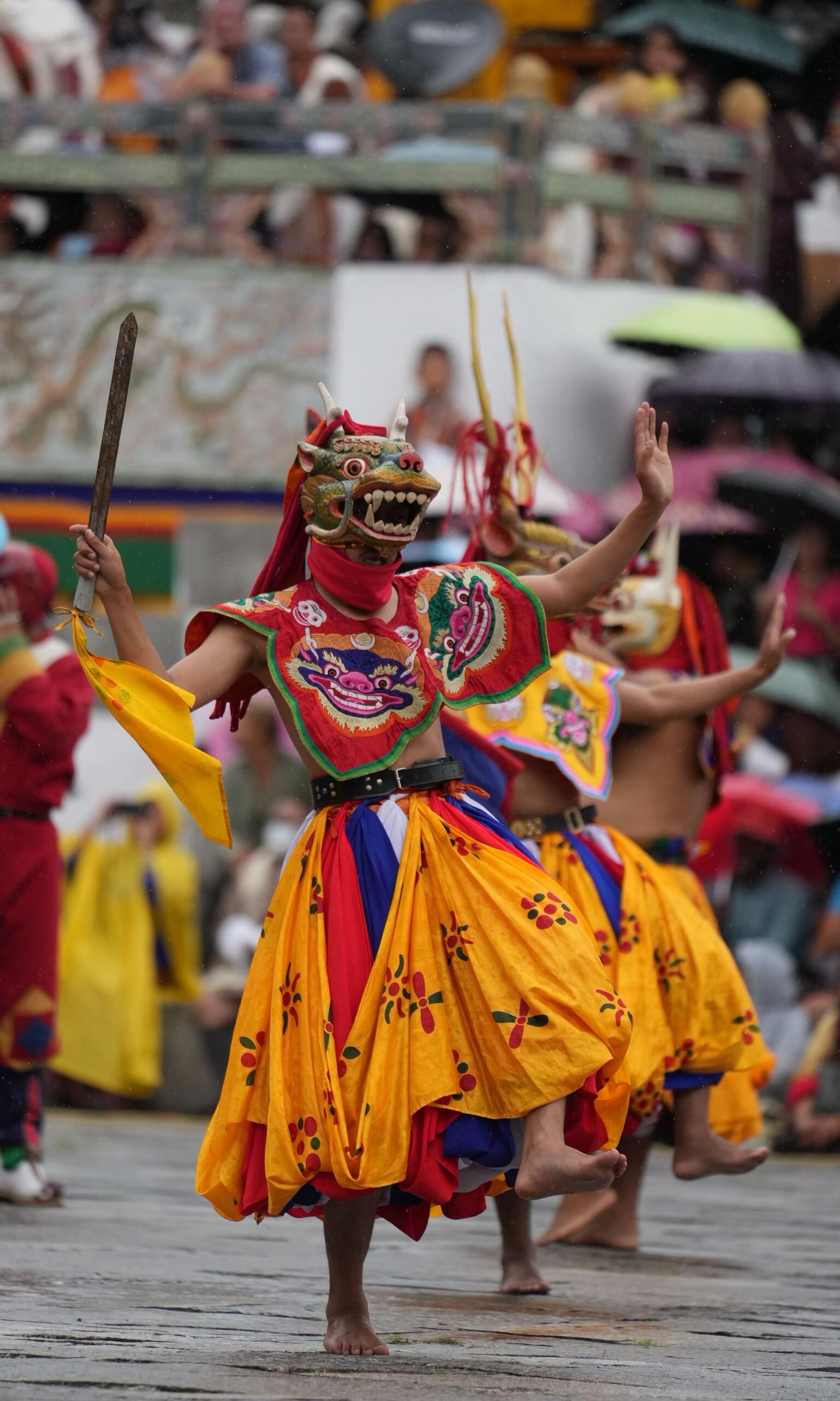 Colorful masked Cham dancer performing at Bhutan Tsechu festival