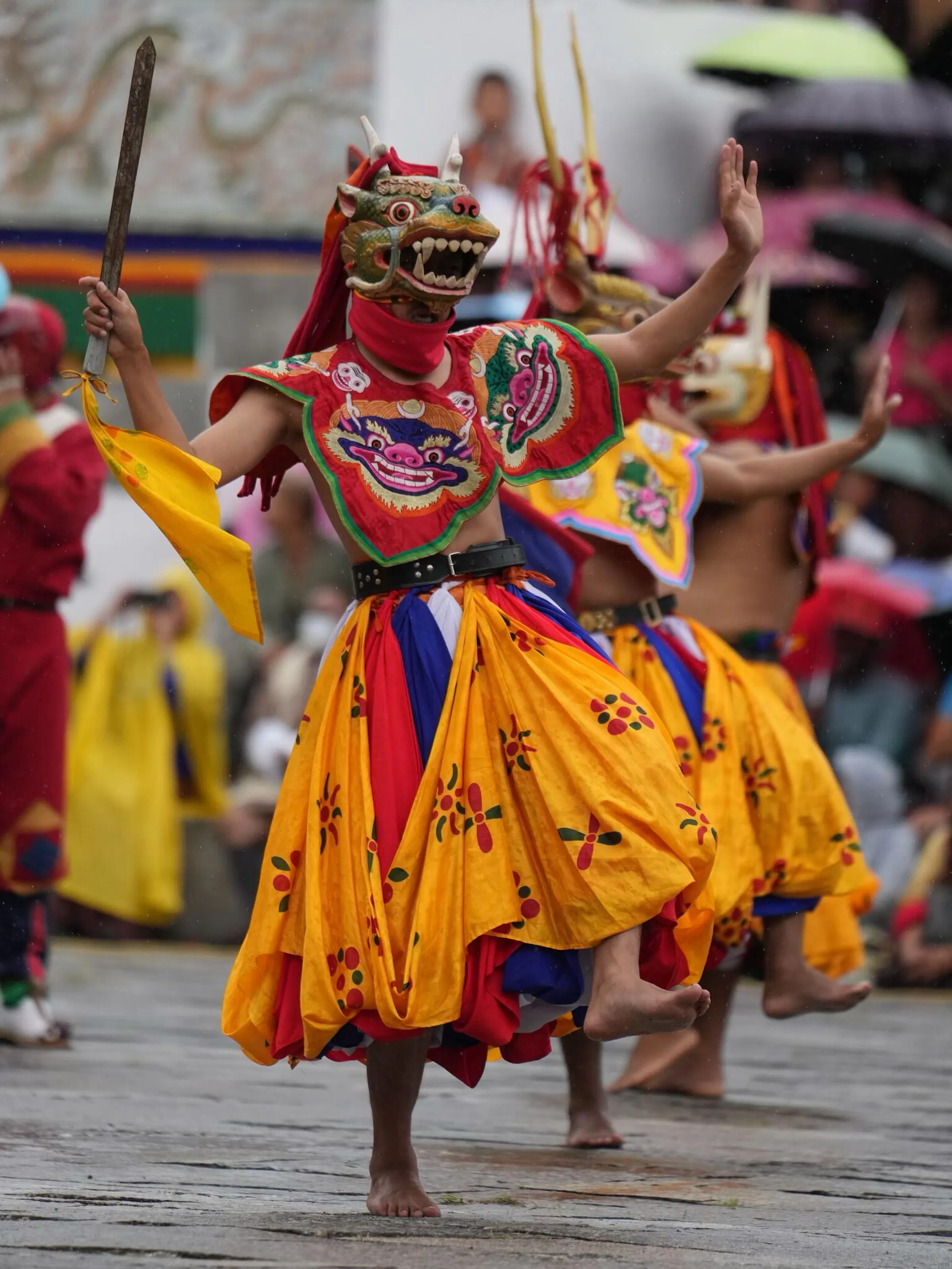 Colorful masked Cham dancer performing at Bhutan Tsechu festival