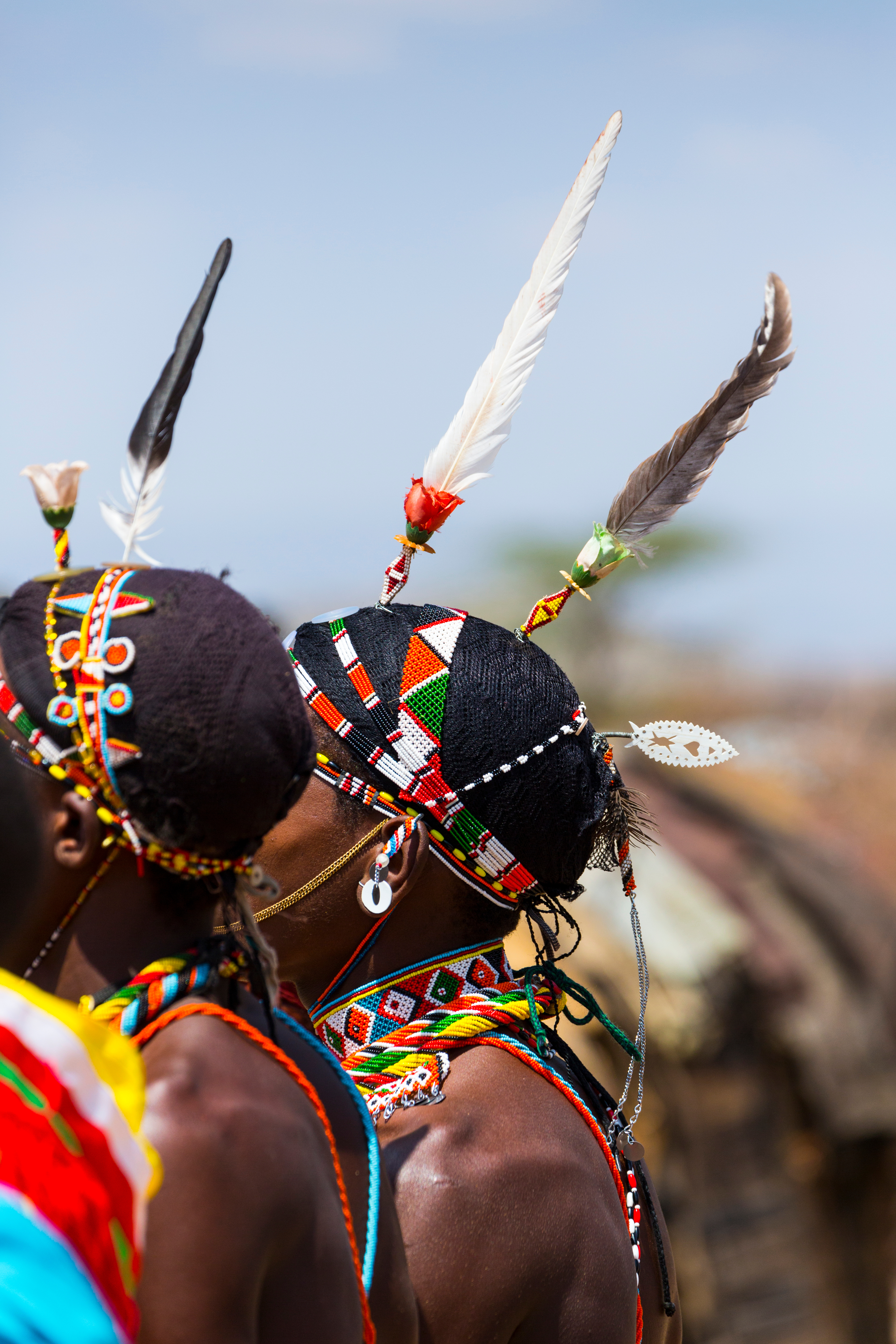 Samburu warriors wearing colorful beaded headdresses with feathers, Kenya