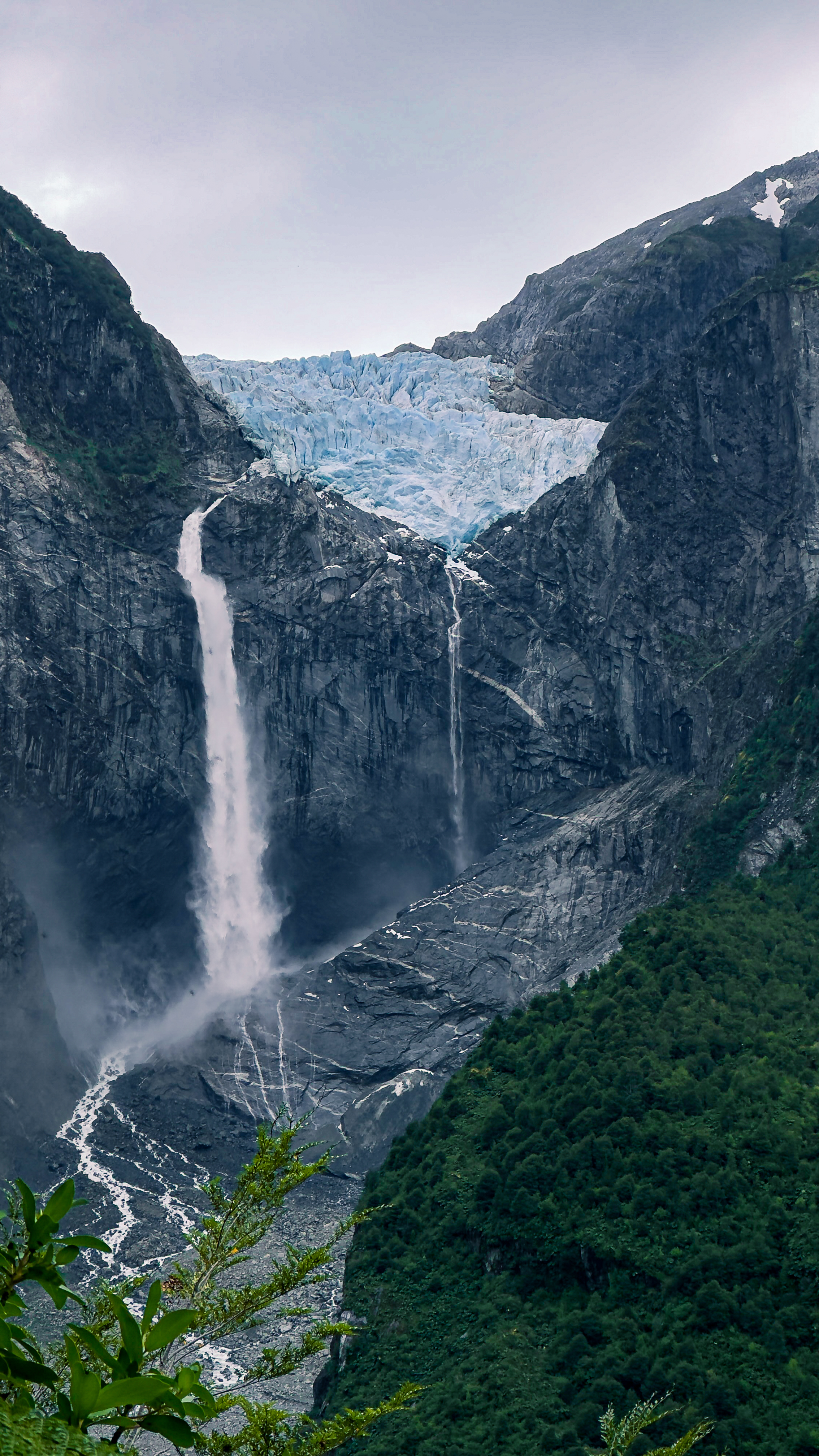 Waterfall cascading from a hanging glacier in Queulat National Park, Chile