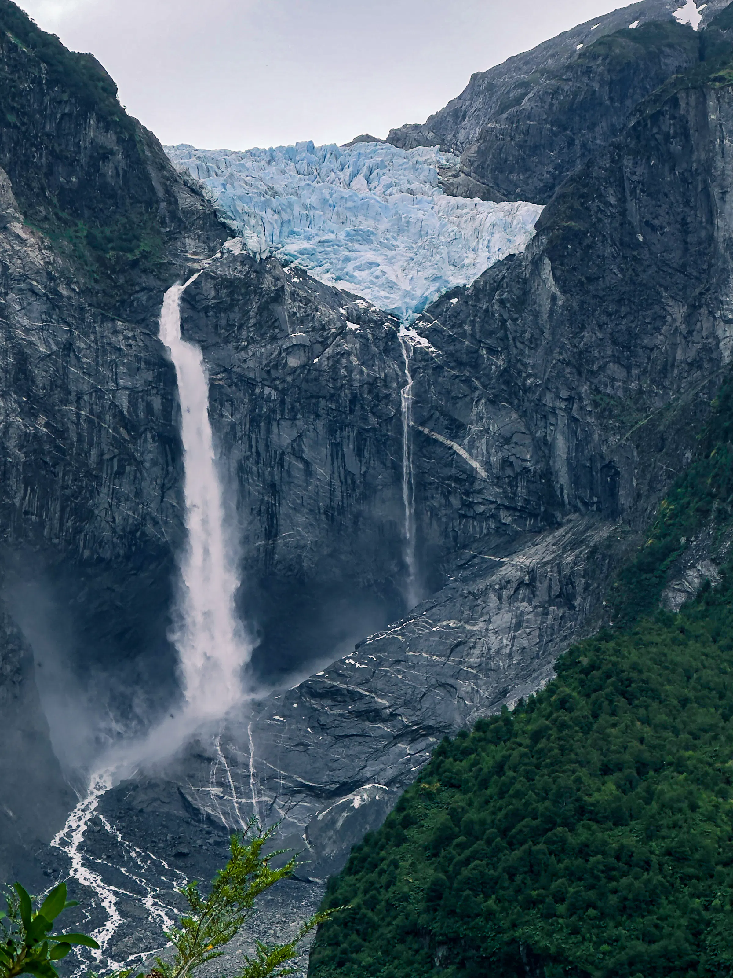 Waterfall cascading from a hanging glacier in Queulat National Park, Chile