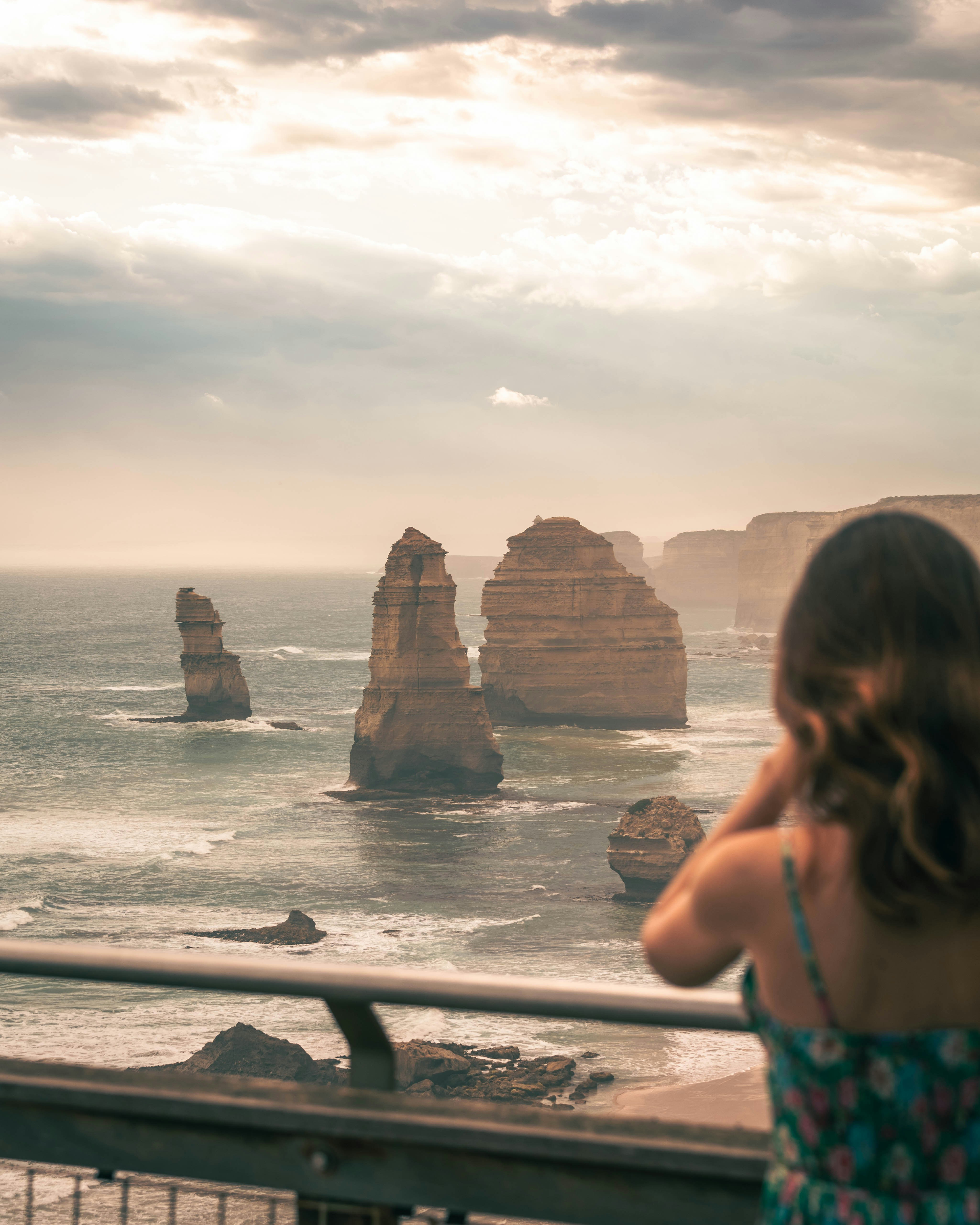 Visitor viewing the Twelve Apostles rock formations along the Great Ocean Road, Victoria