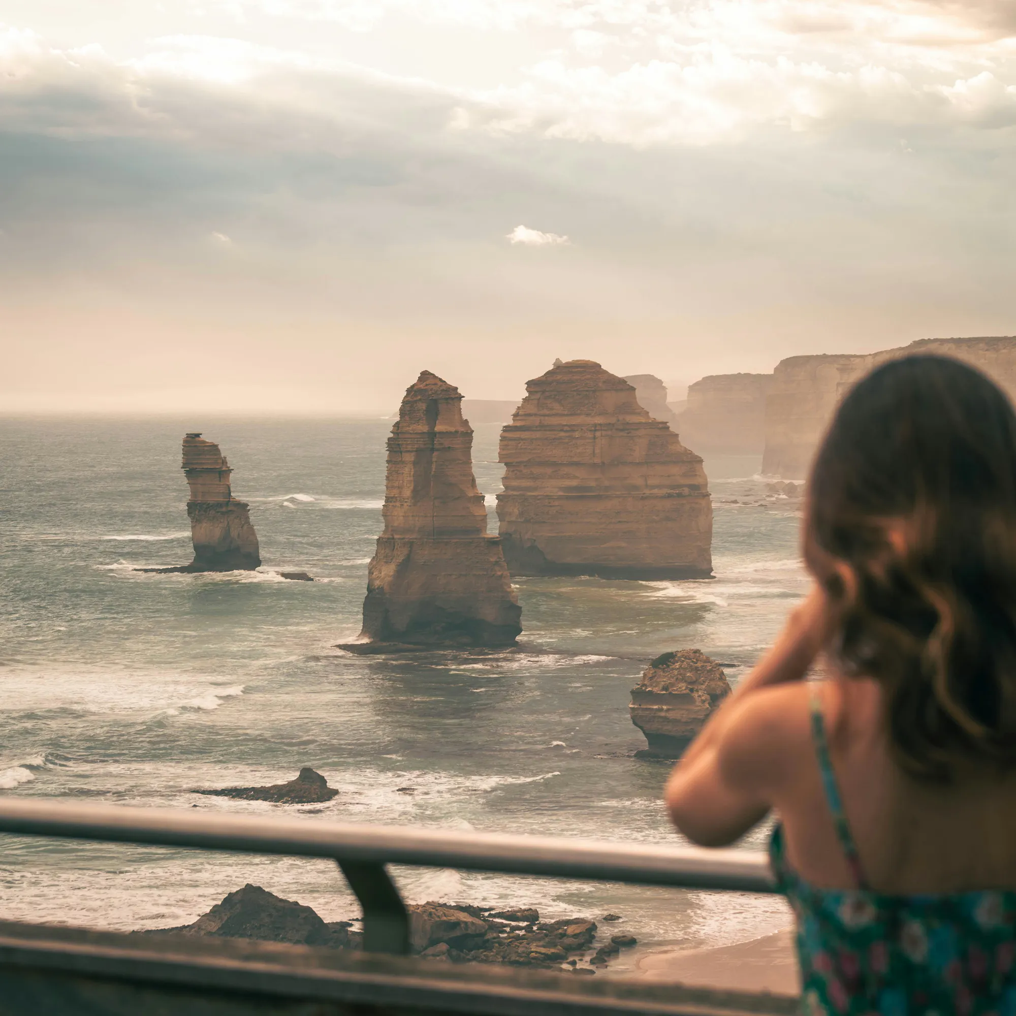 Visitor viewing the Twelve Apostles rock formations along the Great Ocean Road, Victoria