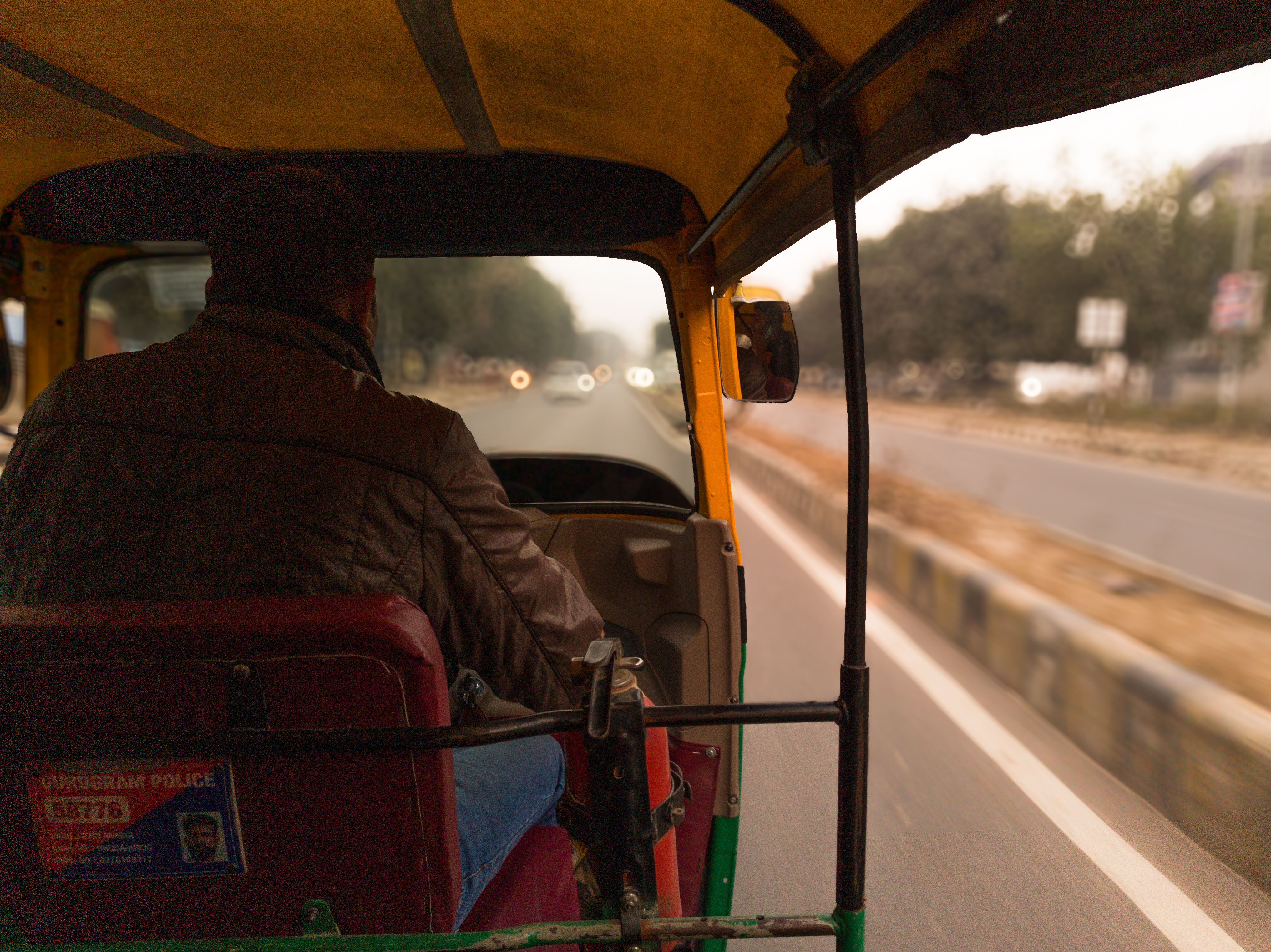 View from inside an auto-rickshaw driving through Delhi, India
