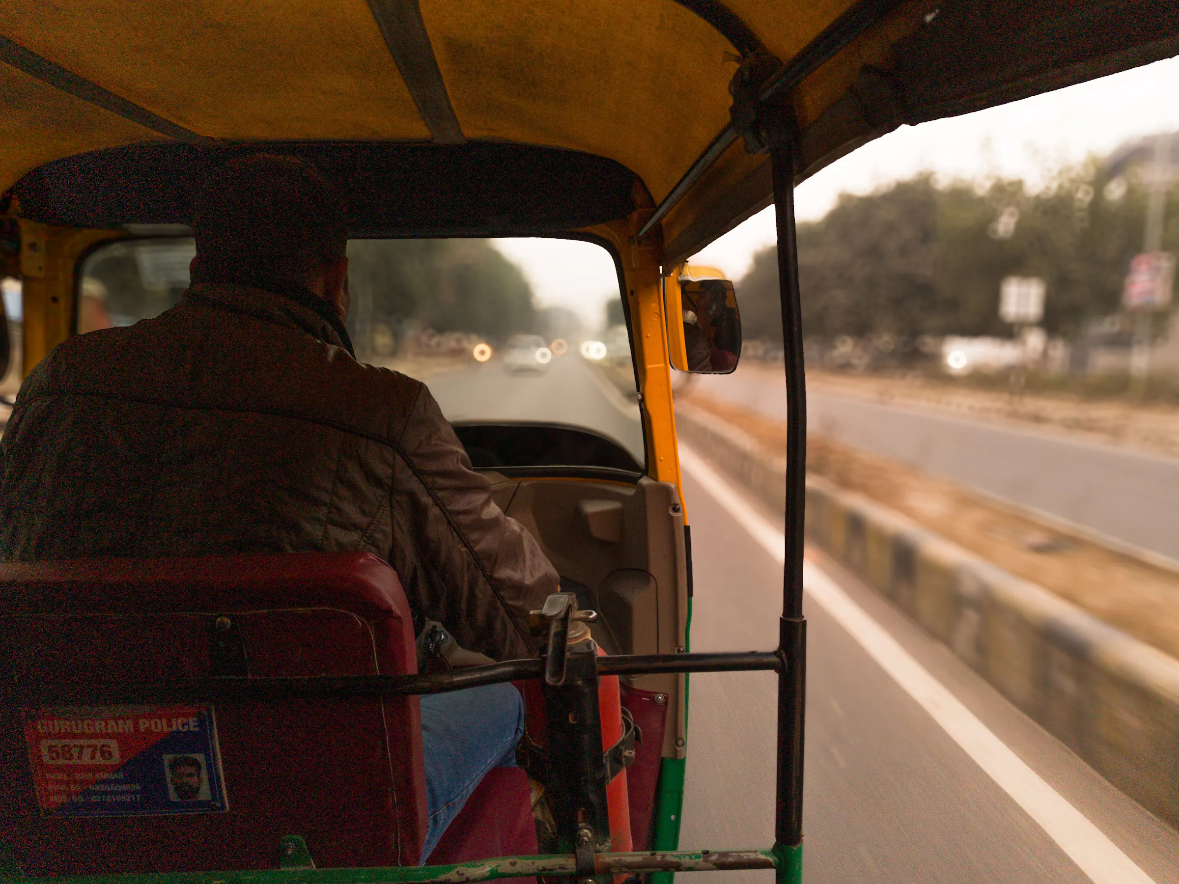View from inside an auto-rickshaw driving through Delhi, India