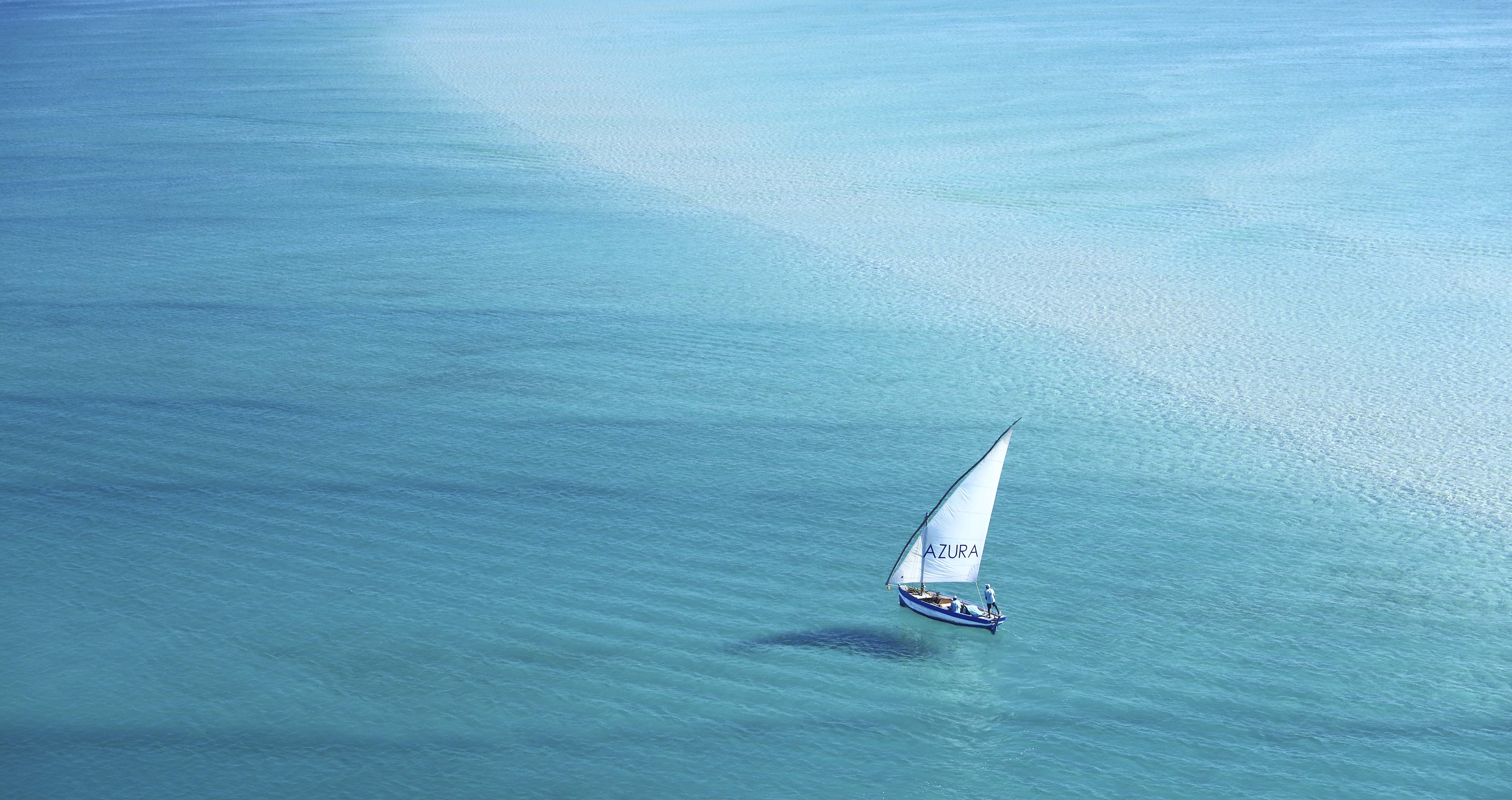 Traditional dhow sailboat on turquoise waters off Bazaruto Archipelago, Mozambique